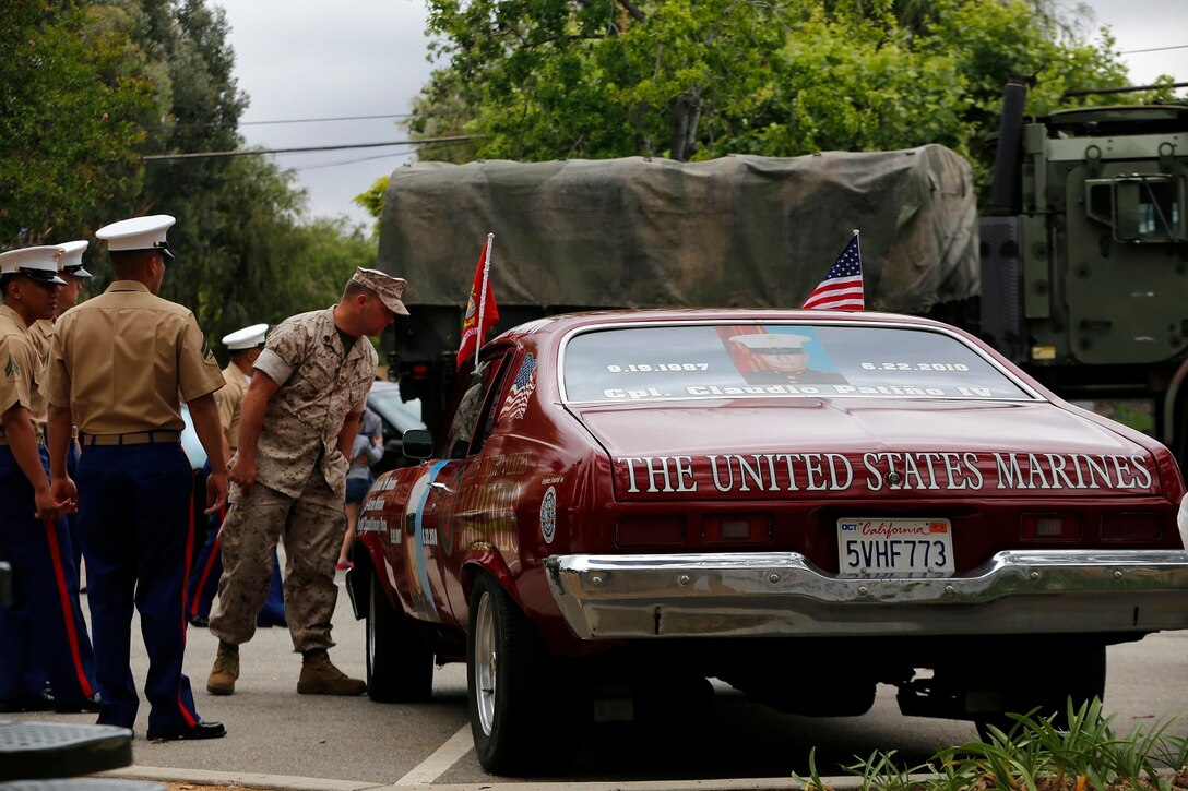 Marines examine a vehicle dedicated to Cpl. Claudio Patino IV at the adoption ceremony in the city of Yorba Linda, May 16. The 11th MEU is a flexible, adaptable and persistent force capable of rapidly responding to crises and contingencies. (U.S. Marine Corps photo by Gunnery Sgt. Rome M. Lazarus/Released)