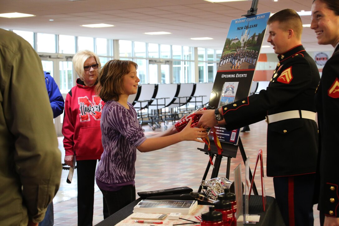 Maya Goss, 11, wins a water bottle, t-shirt and lanyard after completing a sit-up challenge at a Marine Corps Band New Orleans concert May 10, 2015 at East Senior High School in Cheyenne, Wyo. The band conducted their spring tour through Canada and the northern United States April 29 – May 11, 2015. The tour included combined concerts with the HMCS Tecumseh Royal Canadian Navy Reserve Band, as well as the University of Montana wind ensemble. The band performed concerts in Calgary, Alberta, Canada; Missoula and Billings, Mont.; Rapid City, S.D., and Cheyenne, Wyo., giving the Marines a chance to tell the Marine Corps’ story through music across North America. 