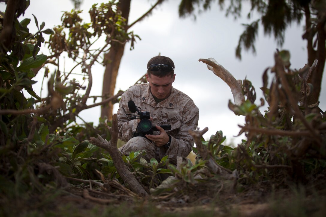 U.S. Marine Corps Sgt. William Holdaway, combat videographer assigned to Marine Forces, Pacific (MARFORPAC) Combat Camera, records footage of amphibious assault operations being conducted by the 15th Marine Expeditionary Unit (MEU) during the MARFORPAC-hosted U.S. Pacific Command Amphibious Leaders Symposium (PALS) aboard Marine Corps Training Area Bellows (MCTAB) May 19, 2015. PALS is designed to bring together senior leaders of allied and partner Marine Corps, naval infantries, and militaries spanning the Indo-Asia-Pacific region with interest in PALS at MCTAB May 19, 2015. The objective of PALS is to have meaningful dialogue on key aspects of maritime and amphibious operations, capability development and interoperability. (U.S. Marine Corps photo by Lance Cpl. Aaron S. Patterson/Released)