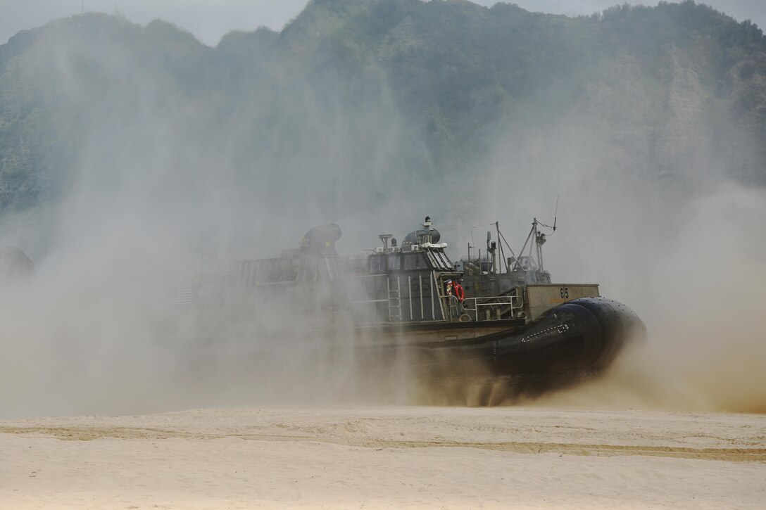 A U.S. Navy Landing Craft Air Cushion lands on the beach of Marine Corps Training Area Bellows, Hawaii during the MARFORPAC-hosted U.S. Pacific Command Amphibious Leaders Symposium (PALS) May 19, 2015. The objective of PALS is to have meaningful dialogue on key aspects of maritime and amphibious operations, capability development, and interoperability. (U.S. Marine Corps photo by Sgt. Sarah Anderson)