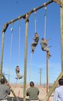 Sgt. Moses Machuca, a substance abuse control officer aboard Marine
Corps Logistics Base Barstow, Calif., yells "CrossFit" at the top of the rope
obstacle during a competition on the obstacle course on MCLB Barstow,
Oct. 10. The O-Course allows Marines to maintain combat readiness and
fitness standards.