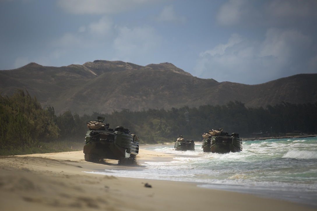 Marines with the 15th Marine Expeditionary Unit drive their amphibious assault vehicles along the beach during the MARFORPAC-hosted U.S. Pacific Command Amphibious Leaders Symposium (PALS) at Marine Corps Training Area Bellows, Hawaii, May 19, 2015. PALS is designed to bring together senior leaders of allied and partner Marine Corps, naval infantries, and militaries spanning the Indo-Asia-Pacific region with interest in military amphibious capability development. This year, 22 nations sent representatives to observe the training. (U.S. Marine Corps photo by Cpl. Matthew J. Bragg)