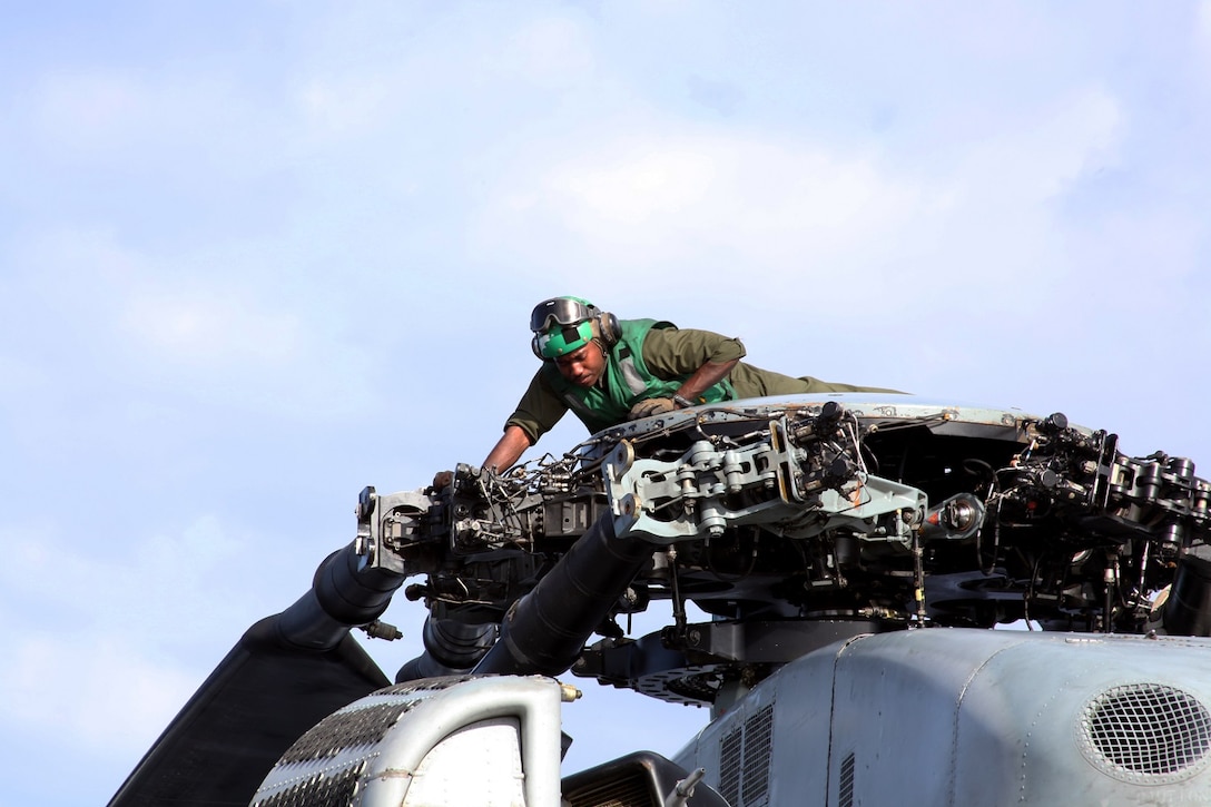 U.S. Marine Lance Cpl. Selim Griggsross provides maintenance on a CH-53E Super Stallion aboard USS Essex (LHD 2) at sea in the Pacific Ocean, May 17, 2015. Torres is an airframe mechanic with Marine Medium Tiltrotor Squadron 161 (Reinforced), 15th Marine Expeditionary Unit. The aviation combat element of the 15th MEU maintains a state of combat readiness through constant upkeep on aircraft while on deployment. (U.S. Marine Corps photo by Staff Sgt. Miguel Carrasco/Released)