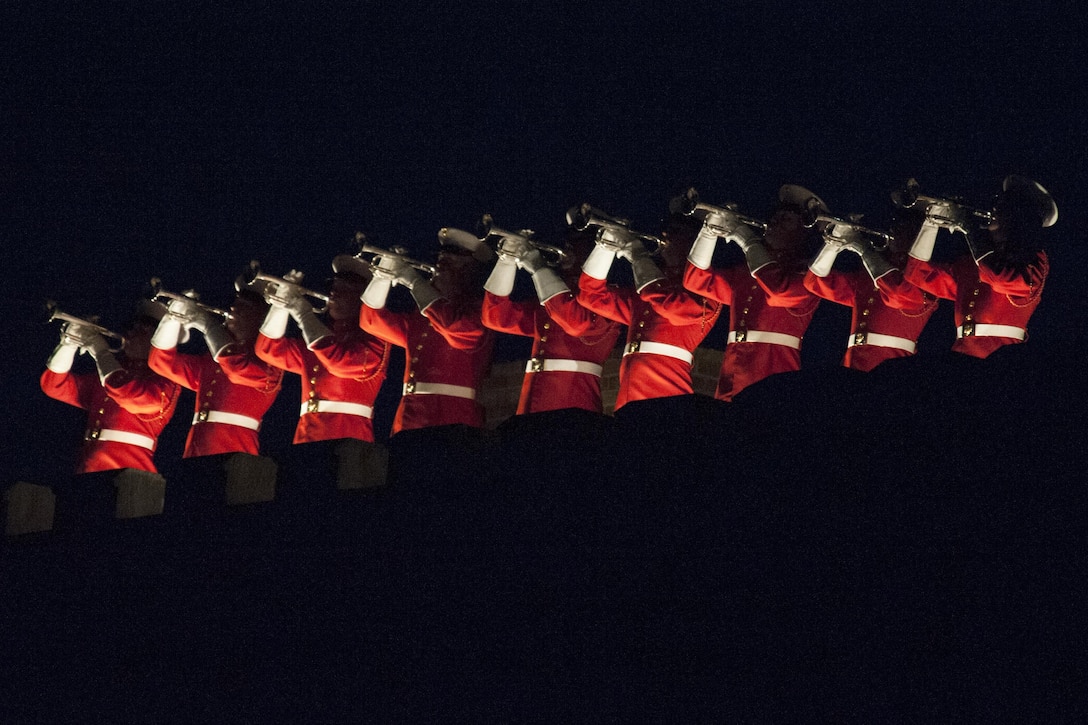 Members of the U.S. Marine Corps Drums and Bugle Corps perform during an evening parade at Marine Barracks Washington, D.C., May 15, 2015. The Evening Parade summer tradition began in 1934 and features the Silent Drill Platoon, the U.S. Marine Band, the U.S. Marine Drum and Bugle Corps and two marching companies. More than 3,500 guests attend the parade every week. (U.S. Marine Corps photo by Lance Cpl. Kayla V. McTaw/Released)