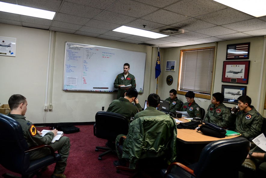36th Fighter Squadron and Republic of Korea air force pilots have a pre-flight briefing during Buddy Wing 15-3 March 24, 2015, at Osan Air Base, ROK. The program places both ROKAF and U.S. Air Force pilots in the same briefings and flying rules that the host unit flies under. (U.S. Air Force photo by Senior Airman Matthew Lancaster)