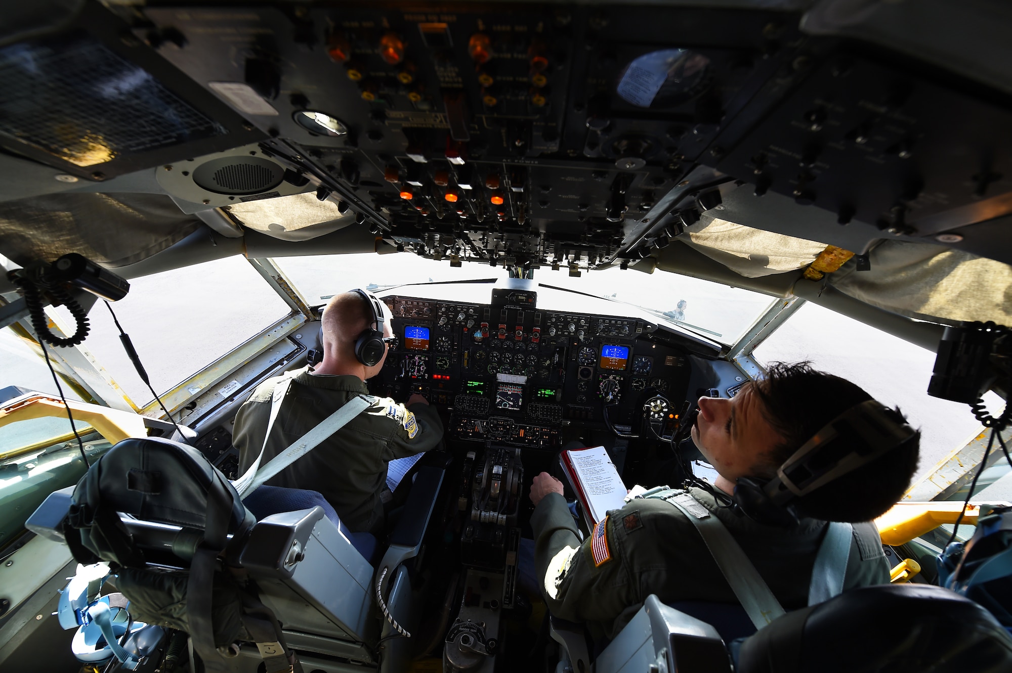 (Left)Capt. Ryan Miller, and Maj. Dan Allen, both pilots for the 96th Air Refueling Squadron, execute preflight checks of a KC-135R Stratotanker on Joint Base Pearl Harbor-Hickam, Hawaii, May 19, 2015. The pilots conducted aerial refueling operations for six F-22 Raptors, from the Hawaiian Raptors. The KC-135 Stratotanker provides the core aerial refueling capability for the United States Air Force and has excelled in this role for more than 50 years. (U.S. Air Force photo by Tech. Sgt. Aaron Oelrich/Released)