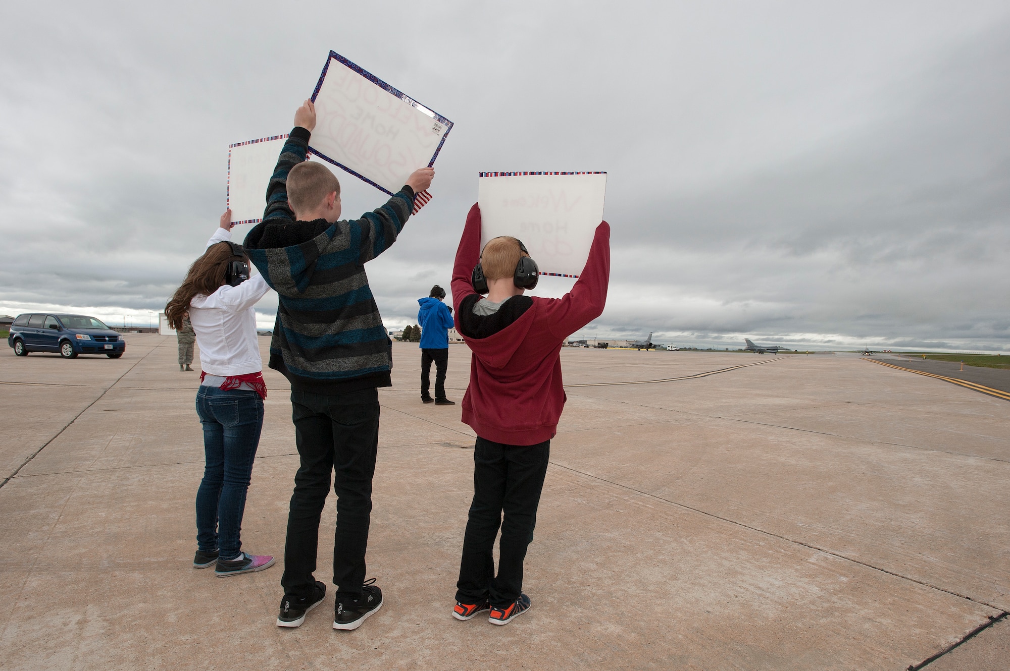 U.S. Air Force Lt. Col. Kurt Tongren???s kids hold up welcome home signs as he taxis in an F-16 Fighting Falcon from the 120th Fighter Squadron, Colorado Air National Guard, at Buckley Air Force Base, Colo., after a deployment to the Republic of Korea, May 19, 2015. Integrating with other U.S. Air Force members, flying daily training mission and providing a Theater Security Package for the past 90 days, this return home marks the completion of the seventh deployment for the "Redeyes" of the 120th FS along with the 140th Wing since Sept. 11, 2001. (U.S. Air National Guard photo by: Tech. Sgt. Wolfram M. Stumpf/RELEASED)