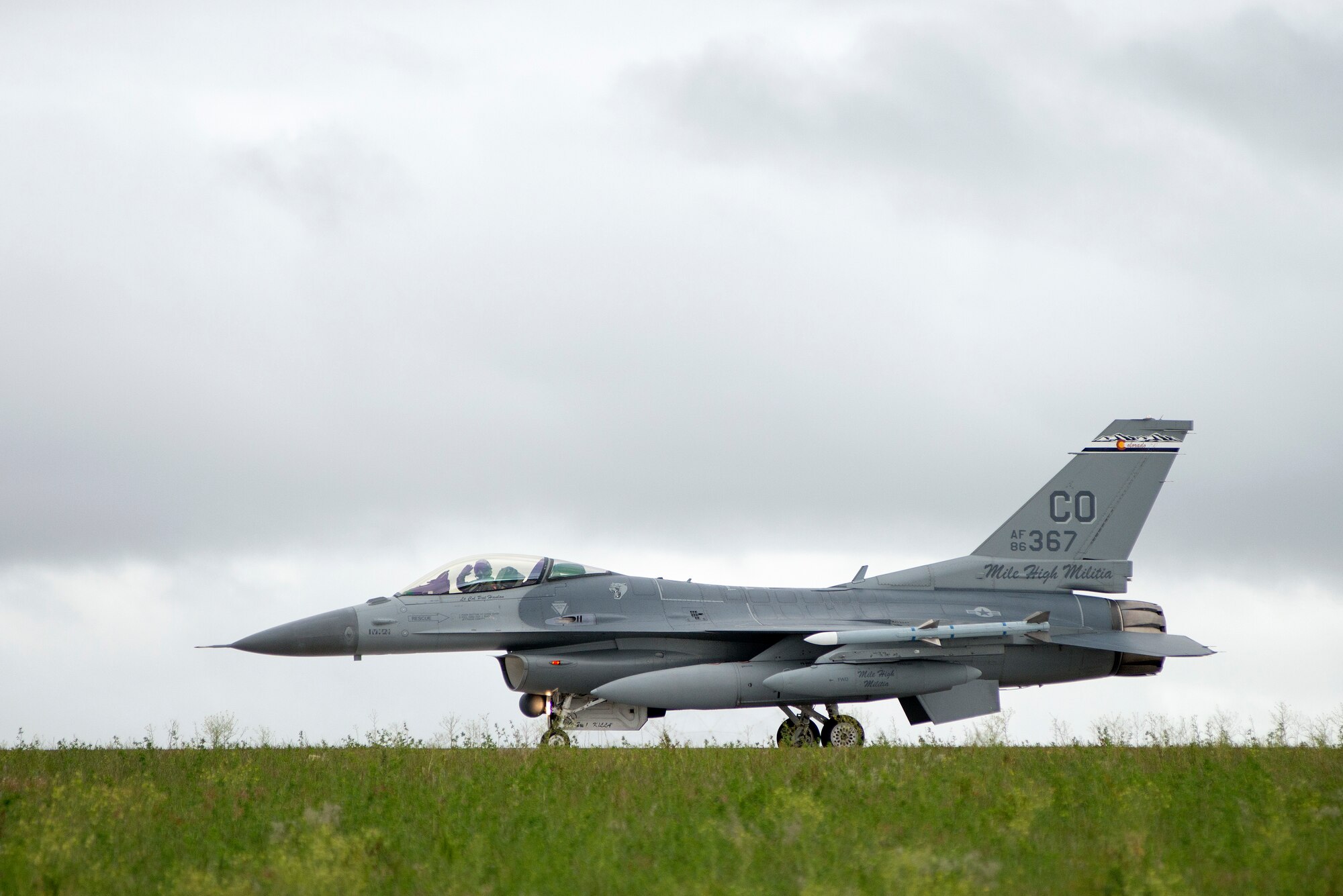 U.S. Air Force Lt. Col. Kurt Tongren waives to his family as he taxis an F-16 Fighting Falcon from the 120th Fighter Squadron, Colorado Air National Guard, at Buckley Air Force Base, Colo., after a deployment to the Republic of Korea, May 19, 2015. Integrating with other U.S. Air Force members, flying daily training mission and providing a Theater Security Package for the past 90 days, this return home marks the completion of the seventh deployment for the "Redeyes" of the 120th FS along with the 140th Wing since Sept. 11, 2001. (U.S. Air National Guard photo by: Tech. Sgt. Wolfram M. Stumpf/RELEASED)