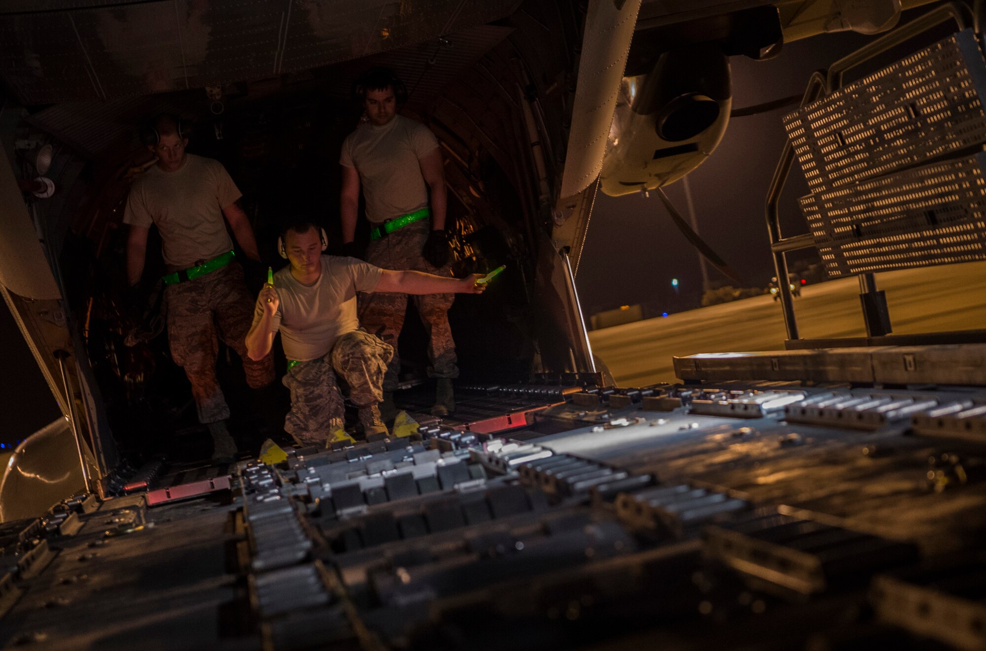Senior Airman Thomas Clark, 817 Contingency Response Wing aerial porter stationed at Joint Base McGuire-Dix-Lakehurst, N.J., spots an Airman operating a Halvorson loader during the Joint Readiness Training Center exercise 15-07, May 15, 2015, at the Alexandria International Airport, La. The exercise was conducted May 14-22. (U.S. Air Force photo/Staff Sgt. Gustavo Gonzalez/RELEASED)