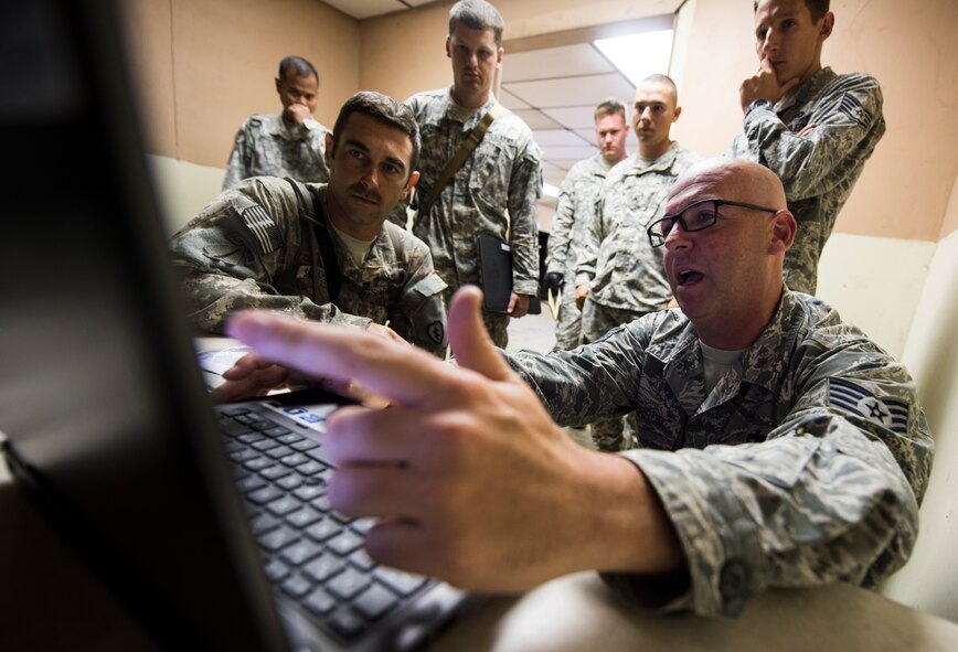 Staff Sgt. Thomas Sherrod, 817th Contingency Response Group aerial porter stationed at Joint Base McGuire-Dix-Lakehurst, N.J., trains members of the U.S. Army on joint inspections during the Joint Readiness Training Center exercise 15-07, May 12, 2015, at the Alexandria International Airport, La. The training will help increase efficiency and expedite the process of loading cargo onto an aircraft during the exercise. (U.S. Air Force photo/Staff Sgt. Gustavo Gonzalez/RELEASED) 