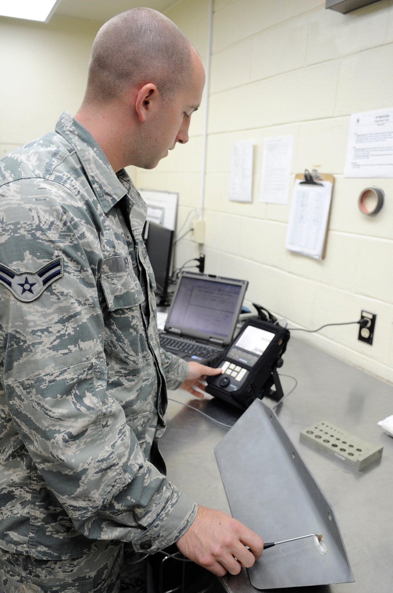 U.S. Air Force Airman 1st Class William Ivey, 18th Equipment Maintenance Squadron Nondestructive Inspection technician, uses an eddy current flaw detector to inspect an aircraft bracket for cracks on Kadena Air Base, Japan, May 19, 2015. Flaw detectors help find defects in aircraft materials and surfaces the human eye can’t see by using electric pulses between the device and the object. (U.S. Air Force photo by Staff Sgt. Marcus Morris) 