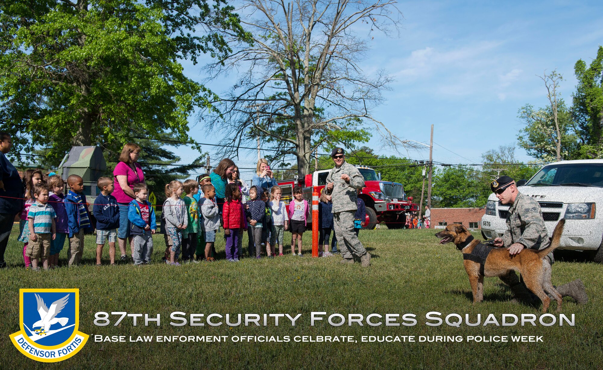 A group of elementary school children talk to military working dog handlers after a demonstration during National Police Week on Joint Base McGuire-Dix-Lakehurst, N.J. May 14, 2015. The 87th SFS, also called the Joint Base Police, provide JB MDL community members with installation entry control, law enforcement, crime prevention, resource protection, force protection and physical security services across the expansive joint base. (U.S. Air Force illustration by Staff Sgt. Katherine Tereyama)