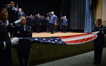 Retirees salute as the U.S. flag is folded during a retreat ceremony May 15, 2015, at Malmstrom Air Force Base, Mont. The retreat ceremony kicked off retiree appreciation weekend events. (U.S. Air Force photo/ Airman 1st Class Dillon Johnston)