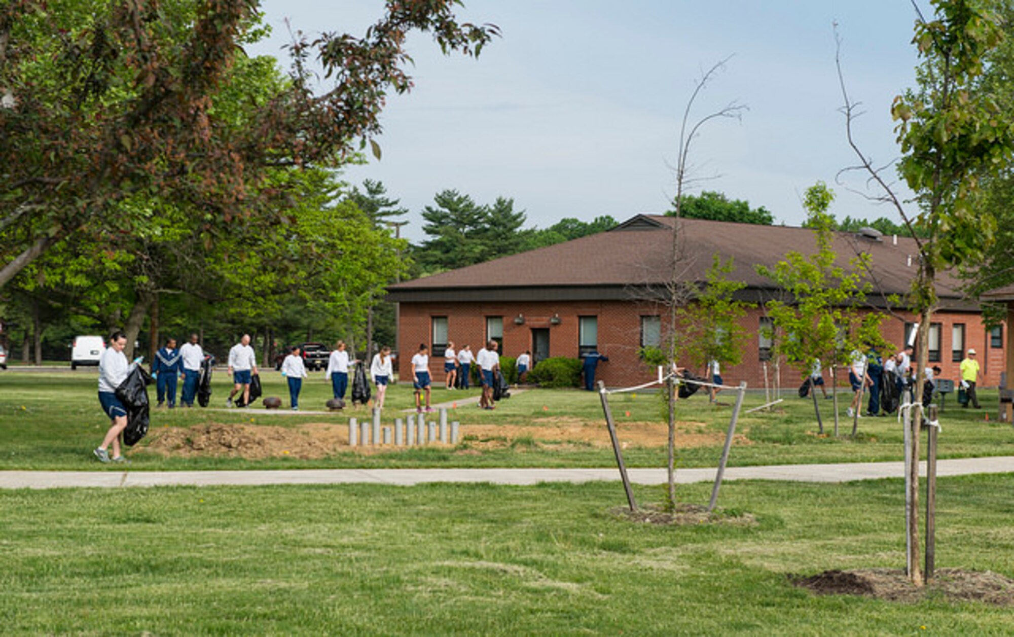 Service members from Joint Base McGuire-Dix-Lakehurst, N.J. walk around picking up trash during base cleanup day, May 15, 2015. Colonels, chief master sergeants, privates, Airmen, Sailors and Soldiers alike, all spent the morning picking up trash, cleaning debris, weeding and trimming vegetation on the base’s 42,000 acre property.
