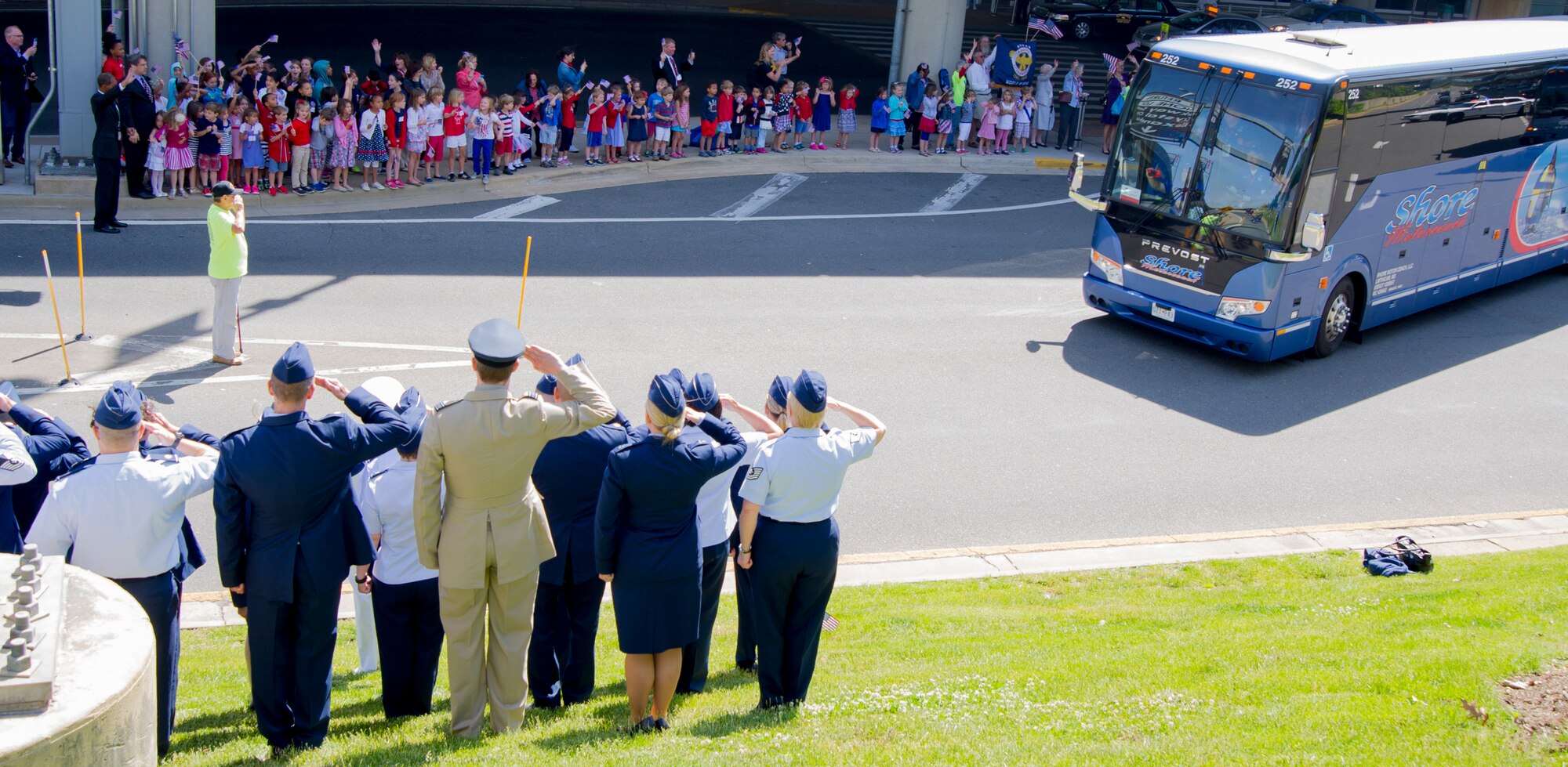 Patrons salute and wave as the Northeast Indiana Honor Flight leaves Ronald Reagan Washington National Airport in Arlington, Va., May 20, 2015. The Honor Flight Network is a non-profit organization created to honor America’s veterans for all their sacrifices by bringing them to visit and reflect at their memorials. (U.S. Air Force photo/Airman 1st Class Ryan J. Sonnier)