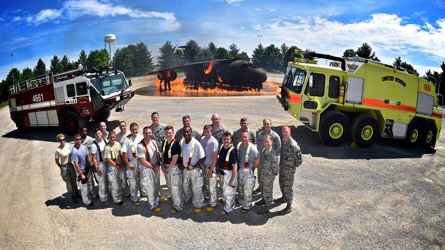 It was a long day on Sunday of the recent unit training assembly as the commander of the 932nd Airlift Wing, Col. Karl Goerke, sixth from left at center, took part in a full gear activity which involved specialized training event using fire and water elements to understand what could happen in real world aircraft situations. The Air Force Reserve Command fire fighters based at Scott Air Force Base worked a full day of drills carrying heavy hoses, moving tanker trucks, driving fire trucks and spraying fires with water. (U.S. Air Force photo/Maj. Stan Paregien)