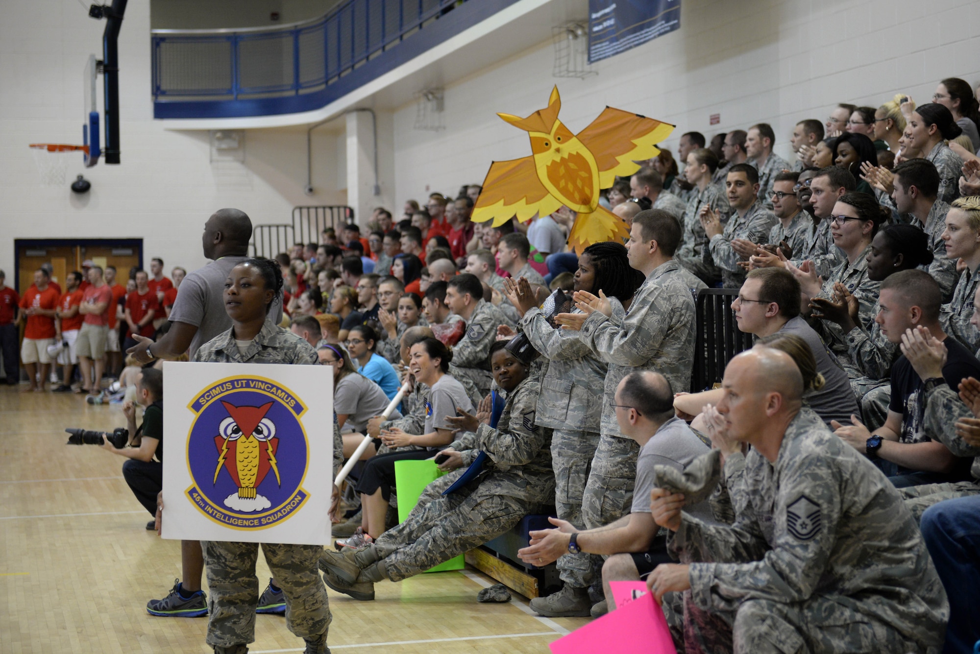 Spectators watch as members from the 30th and 45th Intelligence Squadrons compete in an intramural volleyball championship game at Langley Air Force Base, Va., May 19, 2015. The 45th IS lost to the 30th IS with a score of 25 to 21. (U.S. Air Force photo by Staff Sgt. Teresa J. Cleveland/Released)