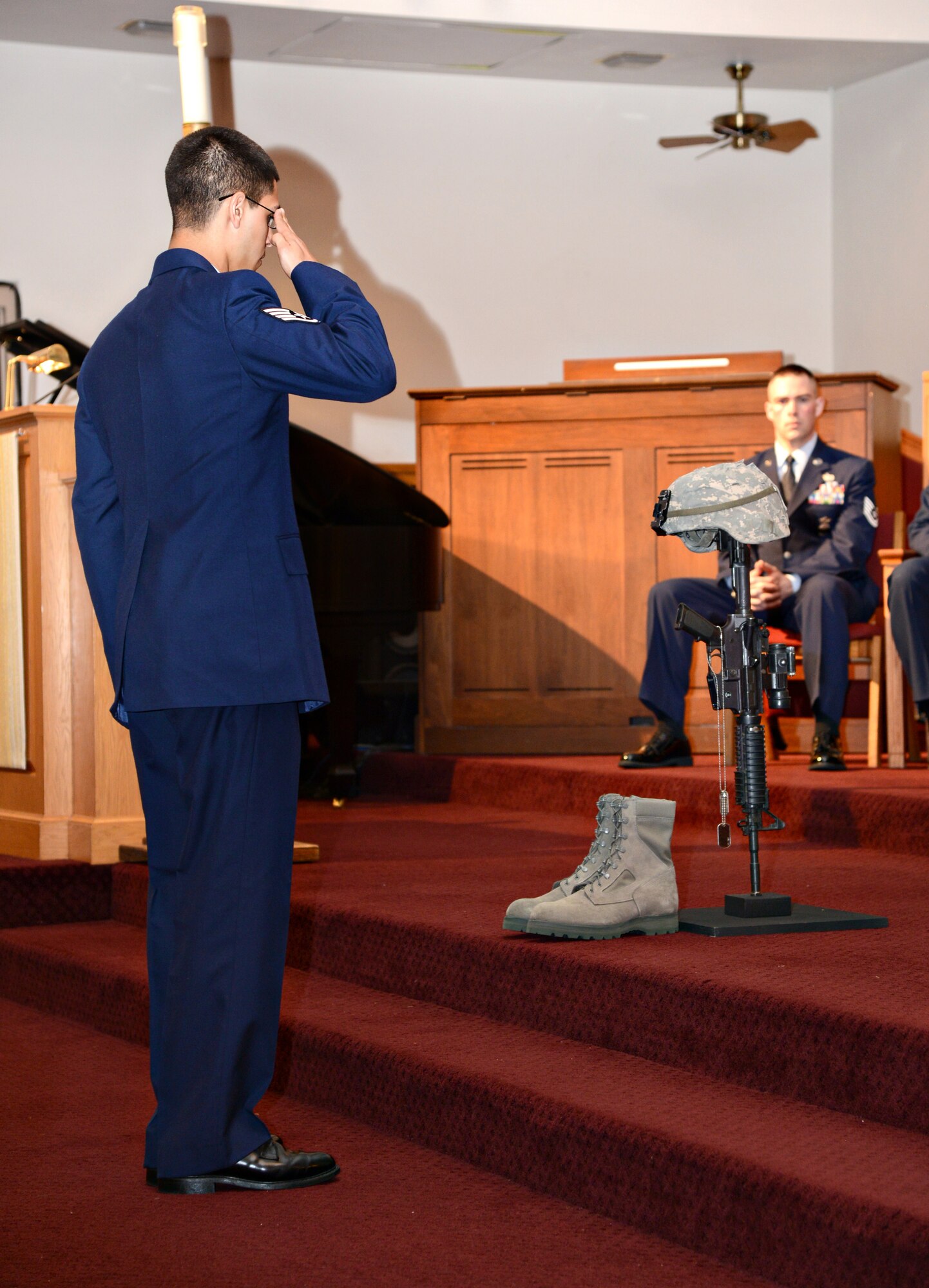 A 72nd Security Forces member salutes a fallen heroes memorial at the 2015 Police Week Memorial Service May 13 at the Tinker Chapel. Members of the 72nd SFS called out the names of police officers from across the country killed in the line of duty during the service.
(Air Force photo by Kelly White/Released)