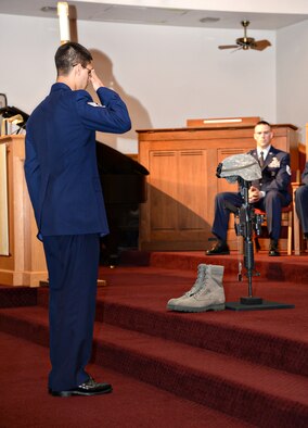 A 72nd Security Forces member salutes a fallen heroes memorial at the 2015 Police Week Memorial Service May 13 at the Tinker Chapel. Members of the 72nd SFS called out the names of police officers from across the country killed in the line of duty during the service.
(Air Force photo by Kelly White/Released)