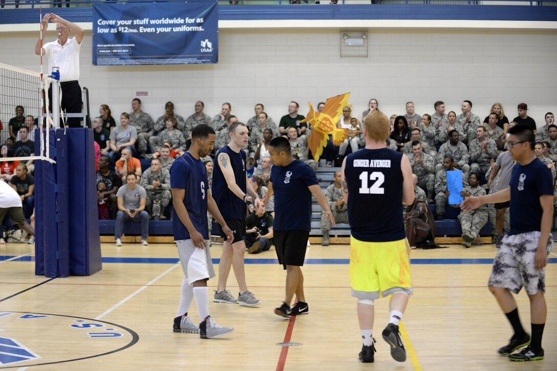 Members of the 45th Intelligence Squadron volleyball team high-five each other during the intramural volleyball championship game at Langley Air Force Base, Va., May 19, 2015. The 45th IS lost to the 30th IS with a score of 21 to their 25. (U.S. Air Force photo by Staff Sgt. Teresa J. Cleveland/Released)
