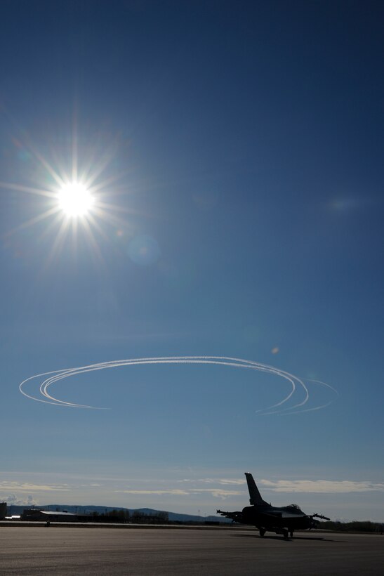 Fighter jets of the 113th Wing, DC Air National Guard leave a circular pattern of contrails in the sky over the flight line Eielson Air Force Base, Alaska during “Red Flag-Alaska 15-2.”
Red Flag-Alaska is an air combat training exercise between Air National Guard, Active Duty and international military personnel.  During the exercise, aviators at Red Flag hone their close air support, interdiction and counter-air skills in simulated combat scenarios.
 (U.S. Air National Guard photo by Capt. Nathan Wallin)