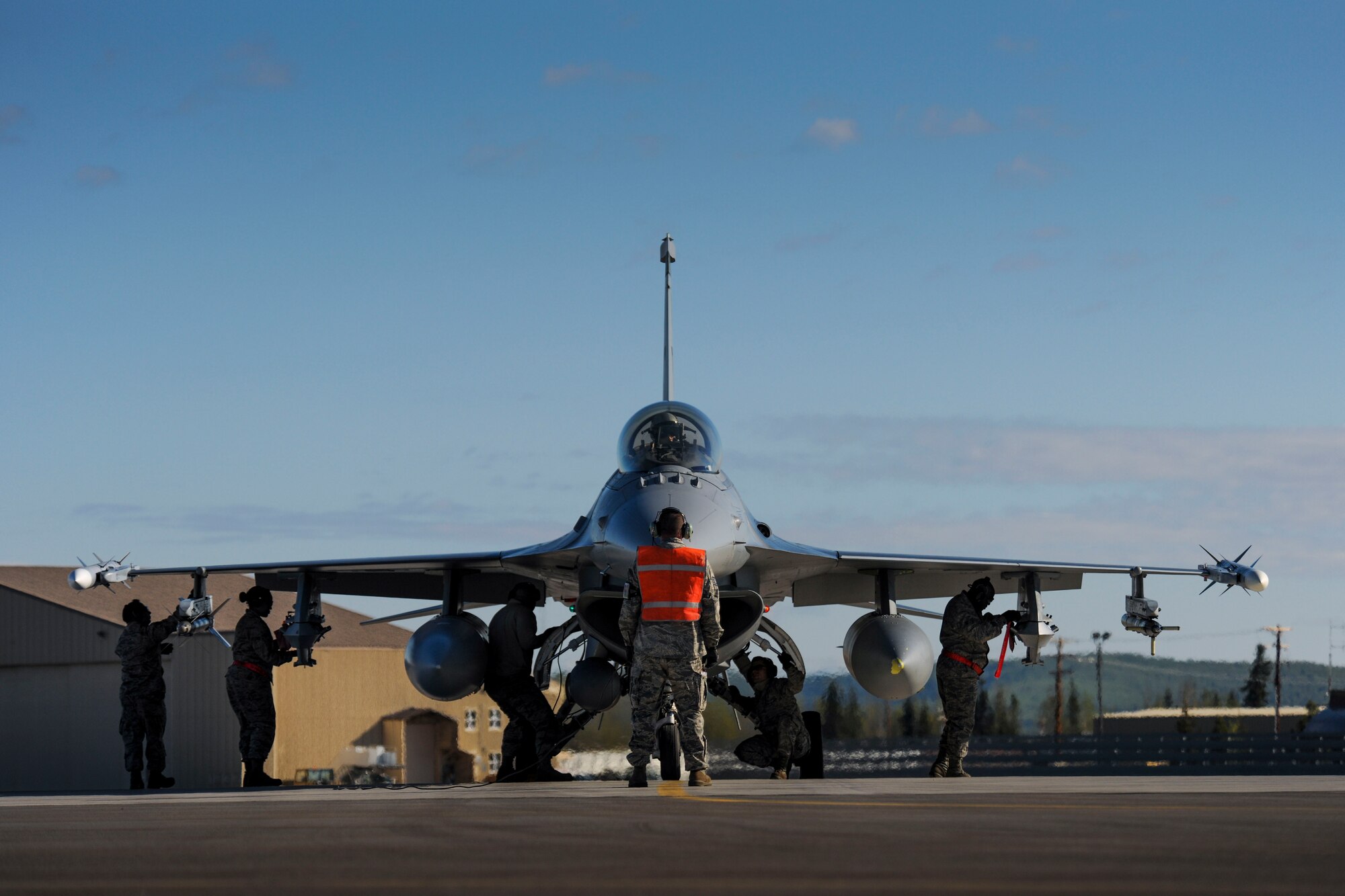 Tech. Sgt. Mark Fox stands face-to-face with an F-16 Fighting Falcon as maintenance personnel make last-minute checks before take off at Eielson Air Force Base, Tuesday, May 12, 2015 during Red Flag-Alaska 15-2. (U.S. Air National Guard photo by Capt. Nathan Wallin)