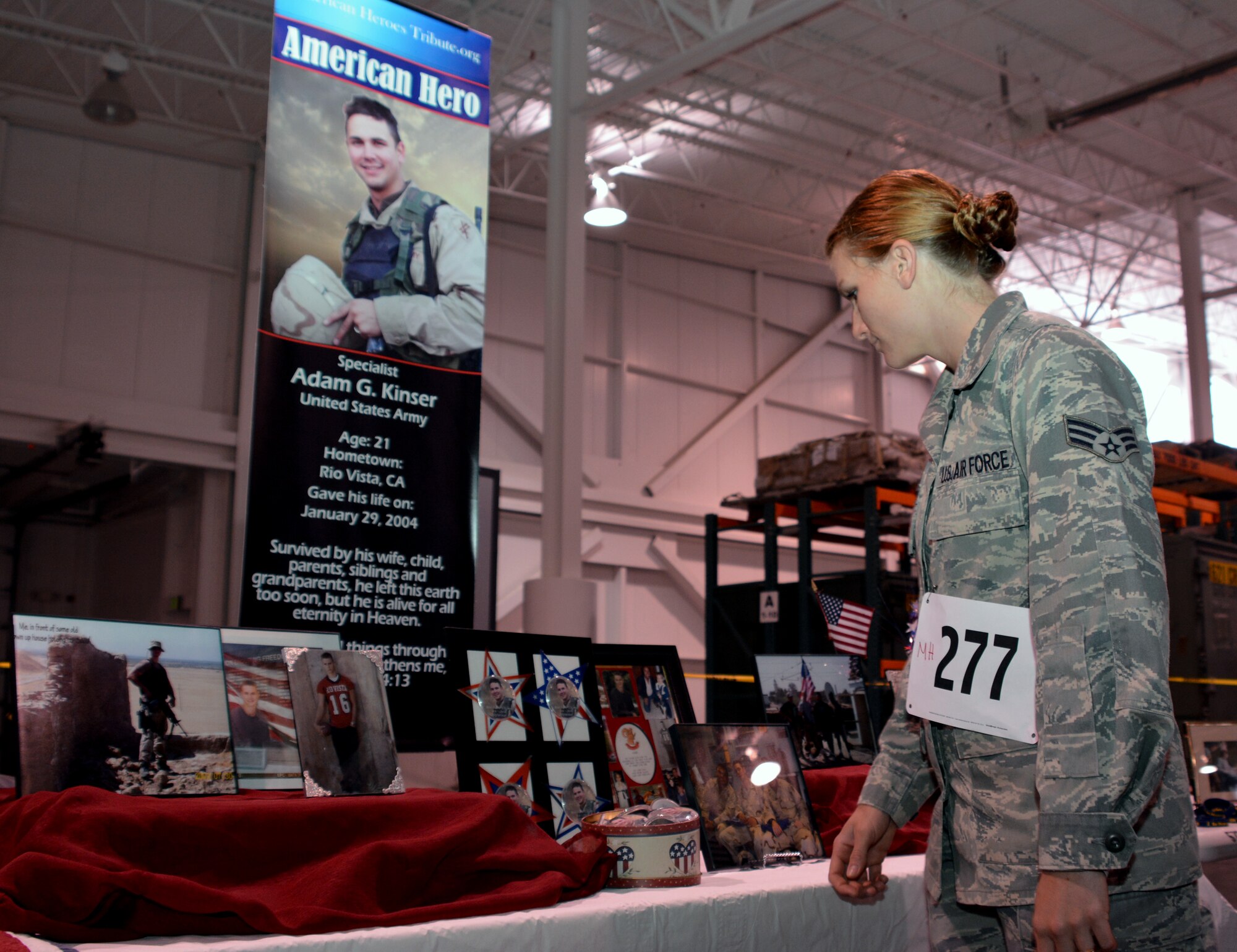 A Travis Airman looks at a display featuring a fallen service member May 16, 2015, during the 5th Annual Gold Star Families Ruck, at Travis Air Force Base, California. More than 270 participants registered for the Travis First Sergeants Council sponsored event, raising more than $3,000.  All proceeds will support the annual GSF Honor and Remembrance event held at the Marine's Memorial Club and Hotel in San Francisco. (U.S. Air Force photo by Senior Airman Charles Rivezzo)
