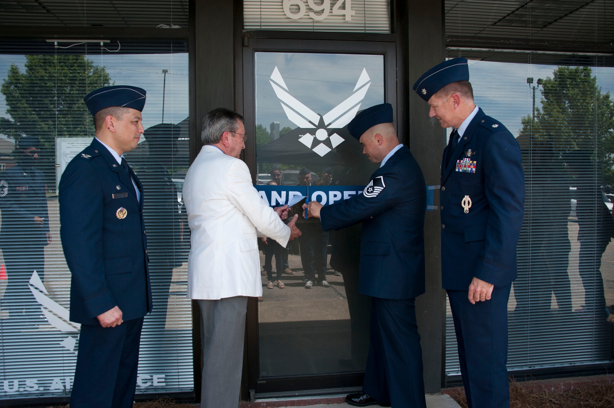 Master Sgt. Jeffrey Storman, A-Flight chief, middle right, and Rick Plaskett, Montgomery Area Chamber of Commerce Defense Technology Development director, middle left, cut the ribbon during the grand opening ceremony of the new flight-centric recruiting office May 13, 2015, Prattville, Alabama. Also attending the ceremony were Col. Robert Borja, 369th Recruiting Group commander, left, and Lt. Col. Johnathan Austin, 331st Recruiting Squadron commander. In an effort to share manpower and resources, the new facility will combine three offices into one. (U.S Air Force photo by Bud Hancock/Cleared)