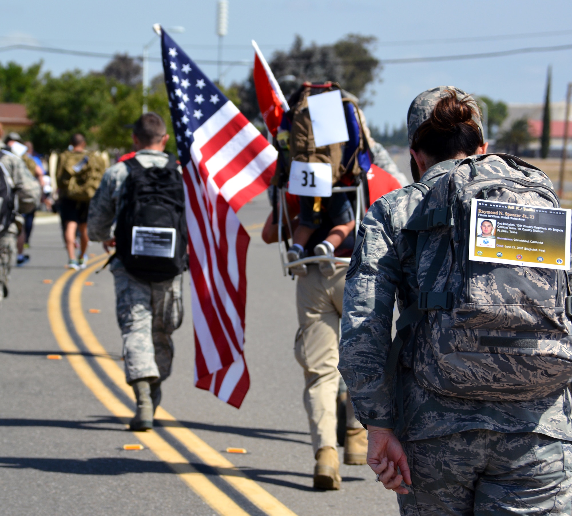 Travis Airmen participate in the 5th Annual Gold Star Families Ruck March, May 16, 2015, at Travis Air Force Base, California. The Travis First Sergeants Council hosted the fifth annual Gold Star Ruck March in support of Gold Star Families throughout the local community and across the country. (U.S. Air Force photo by Senior Airman Charles Rivezzo)