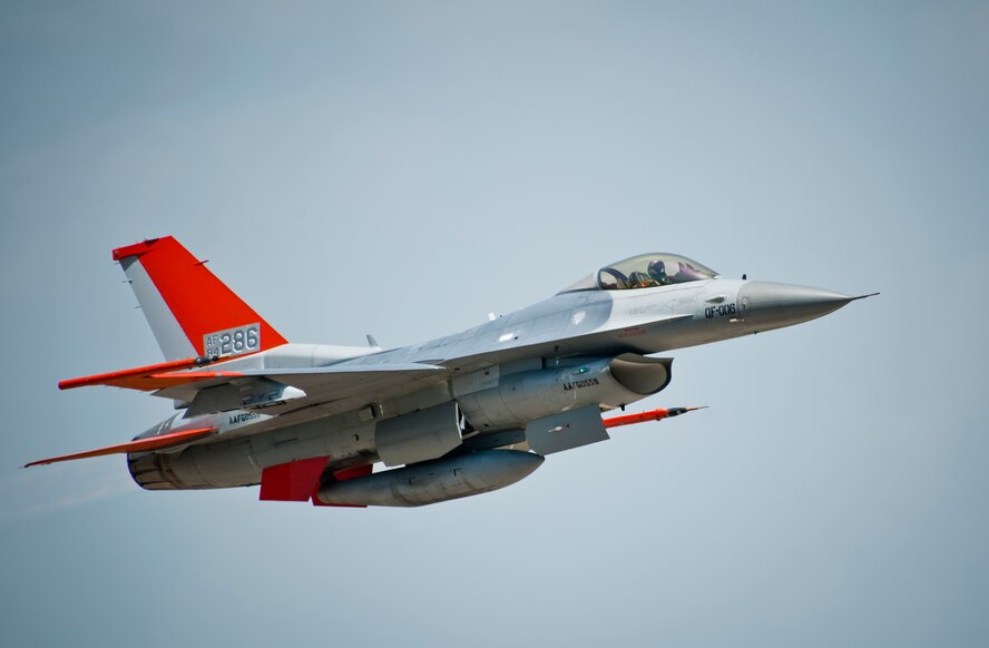 A QF-16 flies across the horizon May 12 at Tyndall Air Force Base, Fla. The QF-16 is a Full Scale Aerial Target that has been modified to be flown with a pilot in the cockpit for training and also without a pilot as a target for live missile testing. The 82nd ATRS received their first QF-16 in September of 2014 and will continue to transition their full scale aerial target program to the new model over the next several months. The 82nd ATRS operates QF-4, QF-16 and BQM-167 targets to provide manned and unmanned aerial targets support for programs across the Department of Defense. (U.S. Air Force photo/Sara Vidoni)