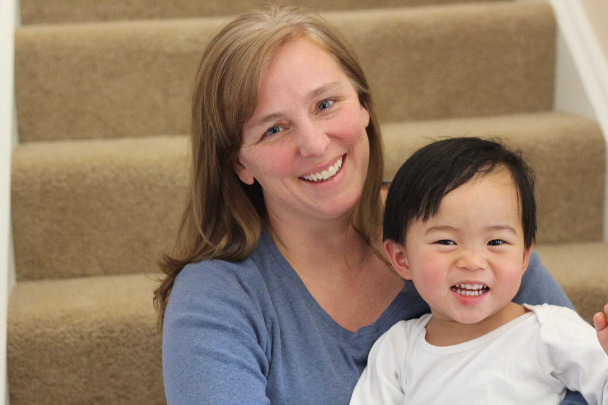 Donna Krueger, wife of Col. Todd Krueger, holds her newly adopted daughter Susan in their home at Hanscom Air Force Base, Mass. The five-member Krueger family traveled to China in December 2014 to pick up the newest addition of their family. (courtesy photo)