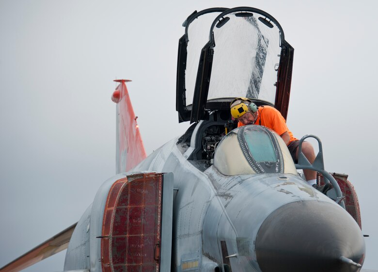 A PAE maintainer performs maintenance checks in the cockpit of a QF-4 prior to takeoff on the drone runway May 12 at Tyndall Air Force Base, Fla. This unmanned QF-4 was used as a full-scale target and shot down by a pilot from the 177th Fighter Wing, a New Jersey Air National Guard unit, who were participating in Combat Archer. Combat Archer is the air-to-air component of the 53rd Wing’s weapons system evaluation program.  The 82nd Aerial Targets Squadron operates QF-4, QF-16 and BQM-167 targets to provide manned and unmanned aerial targets support for programs across the Department of Defense. The QF-4 mission for the 82nd ATRS at Tyndall came to an end in May, with the squadron transitioning to QF-16s for all future full-scale target operations. (U.S. Air Force photo/Sara Vidoni)