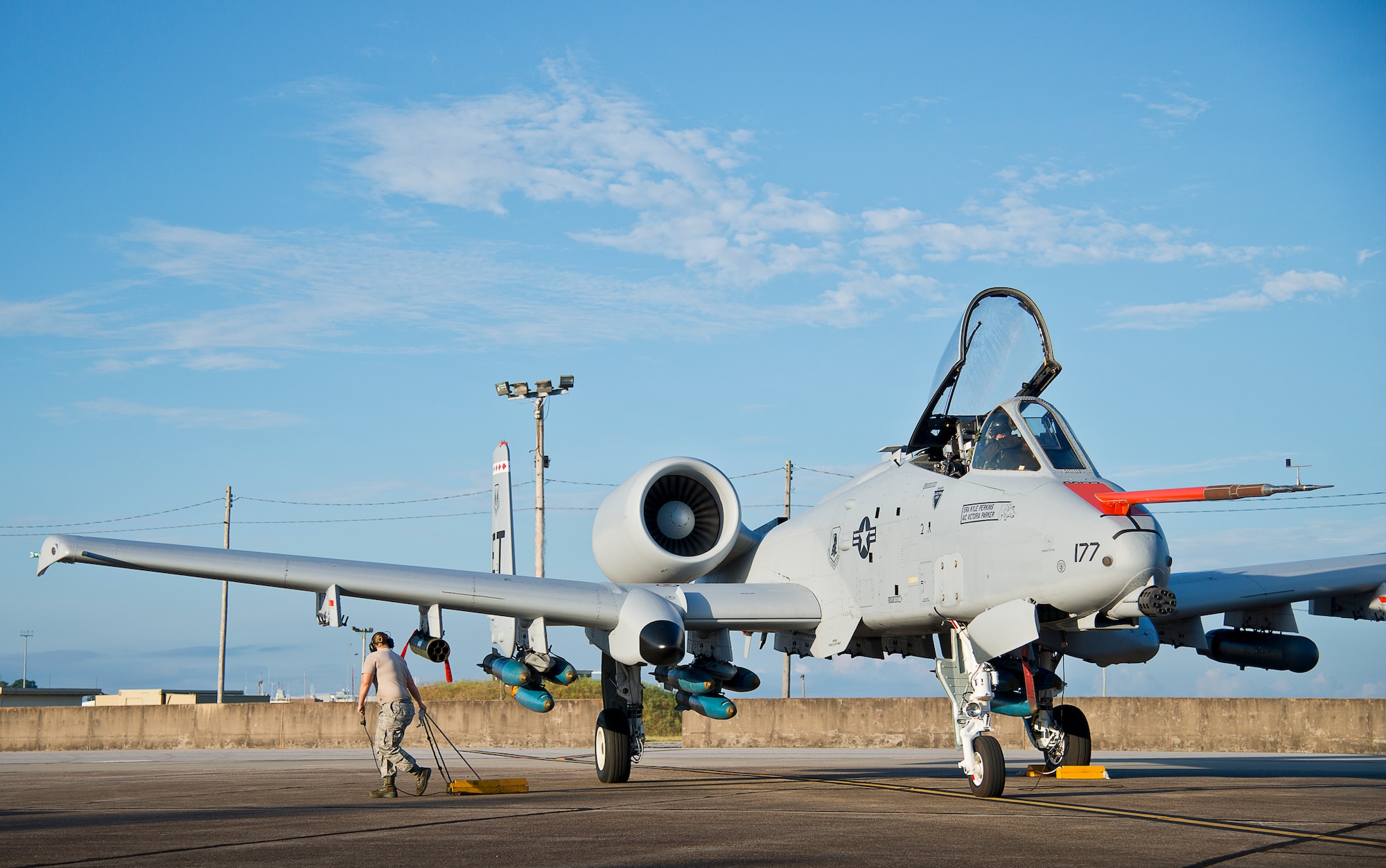 Senior Airman Victoria Parker, 96th Aircraft Maintenance Squadron, pulls the chocks from the wheels of an A-10 Thunderbolt II prior to a morning takeoff from Eglin Air Force Base, Fla., May 19.  The aircraft was loaded with approximately nine MK-82s, seven missiles and a full 30mm round load for the GAU-8. The sortie was to test the weapons worked properly with new aircraft software upgrades.  (U.S. Air Force photo/Samuel King Jr.)