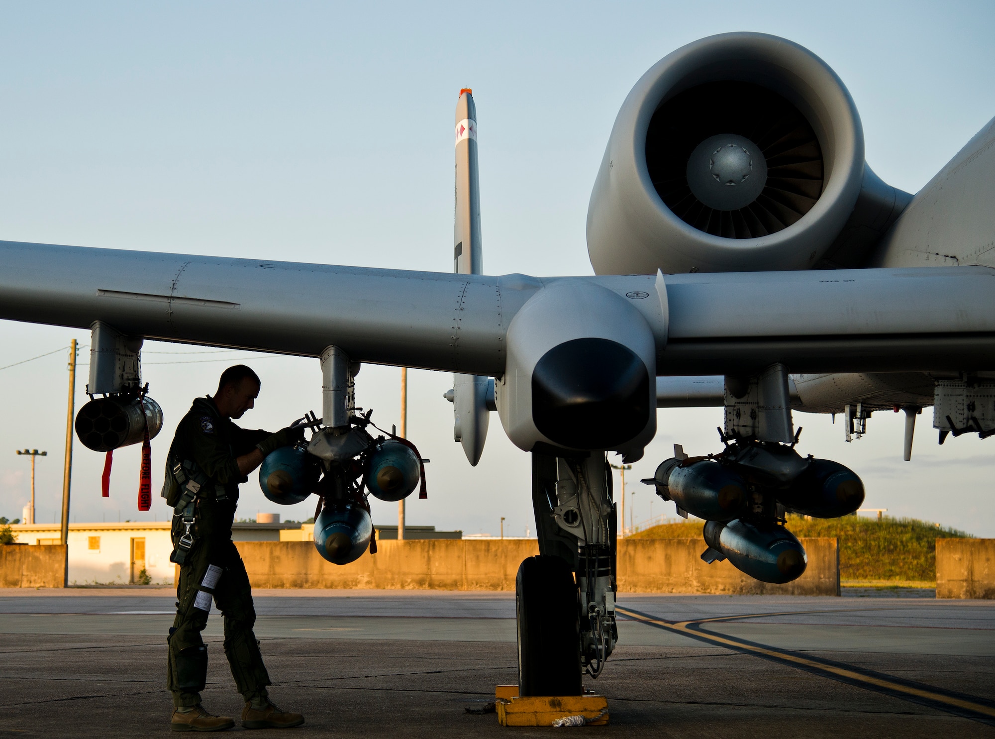 Maj. Joe McGill, a flyer for the 40th Flight Test Squadron, performs checks on the bombs attached to the wing of an A-10 Thunderbolt II prior to a morning takeoff from Eglin Air Force Base, Fla., May 19.  The aircraft was loaded with approximately nine MK-82s, seven missiles and a full 30mm round load for the GAU-8. The sortie was to test the weapons worked properly with new aircraft software upgrades.  (U.S. Air Force photo/Samuel King Jr.)