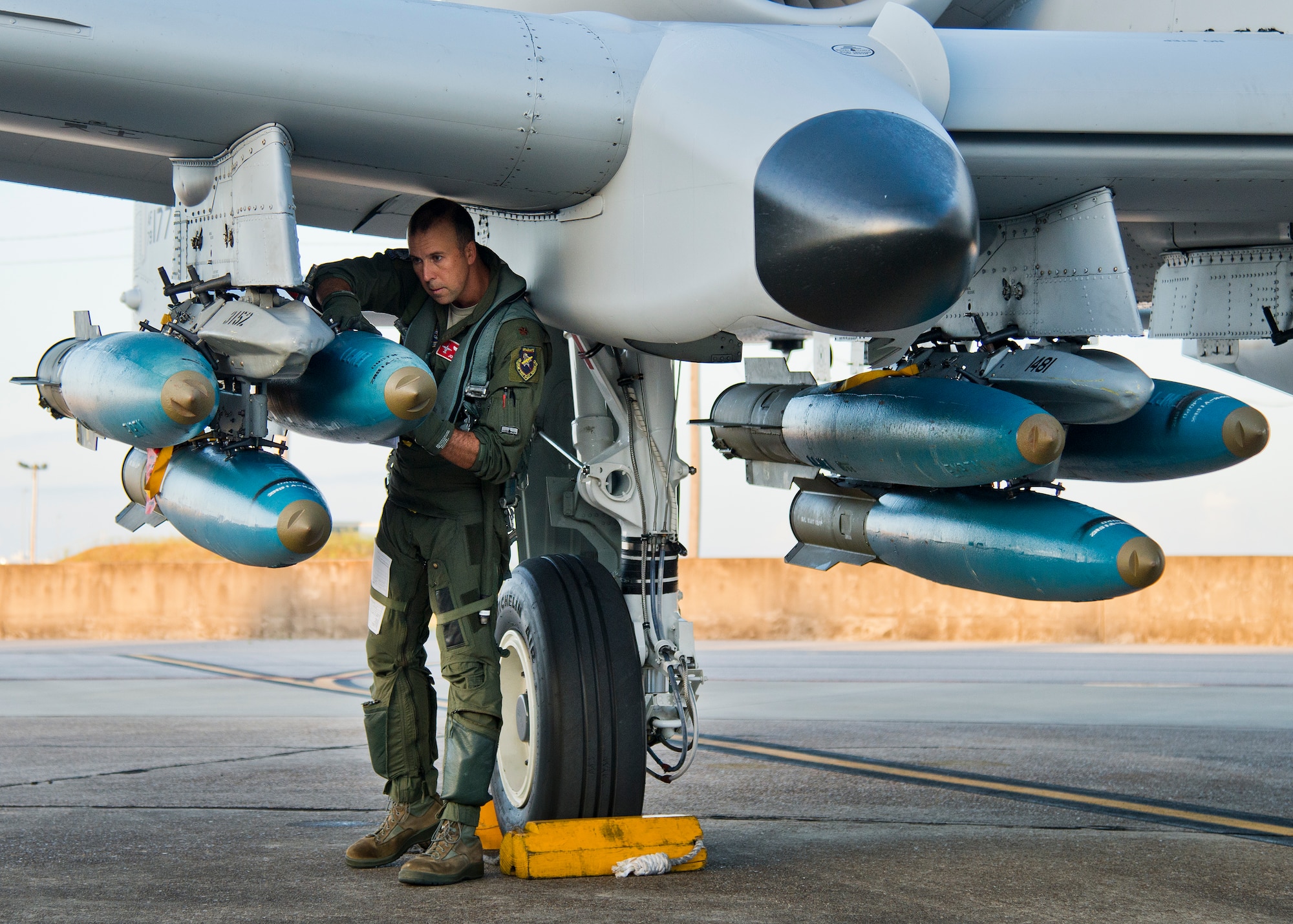 Maj. Joe McGill, a flyer for the 40th Flight Test Squadron, performs checks on the bombs attached to the wing of an A-10 Thunderbolt II prior to a morning takeoff from Eglin Air Force Base, Fla., May 19.  The aircraft was loaded with approximately nine MK-82s, seven missiles and a full 30mm round load for the GAU-8. The sortie was to test the weapons worked properly with new aircraft software upgrades.  (U.S. Air Force photo/Samuel King Jr.)