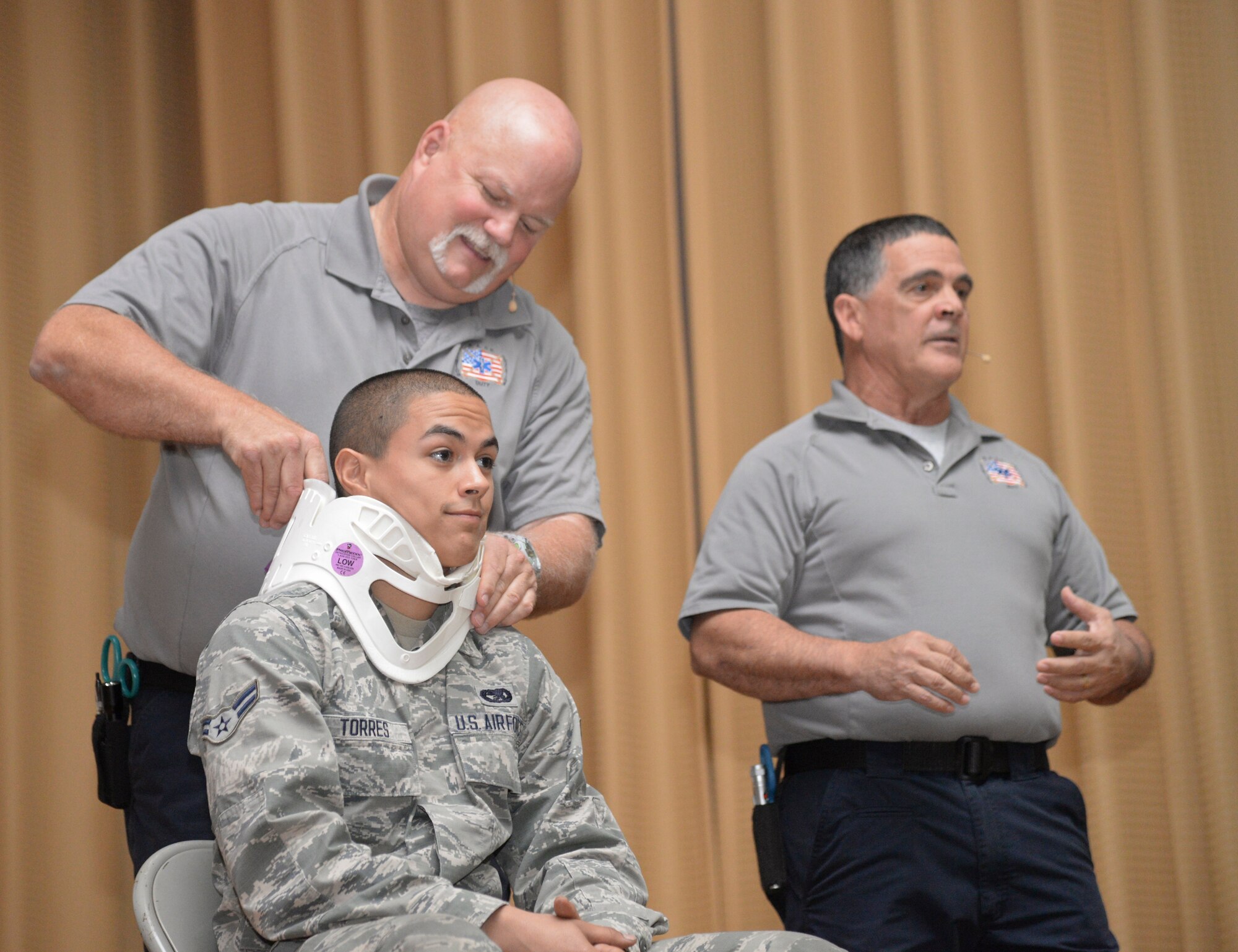(Left) Greg McCarty, Florida Stay Alive From Education Inc. community outreach, applies a neck brace to Airman 1st Class Xavier Torres, 6th Logistics Readiness Squadron, during a “Street Smart” presentation at MacDill Air Force Base, Fla., May 19, 2015. The goal of S.A.F.E. is to offer information that will allow the audience to make rational decisions concerning their safety and well-being while on the road, thus reducing injuries and fatalities, giving them the opportunity to become responsible and healthy adults. (U.S. Air Force photo by Senior Airman Vernon L. Fowler Jr./Released)