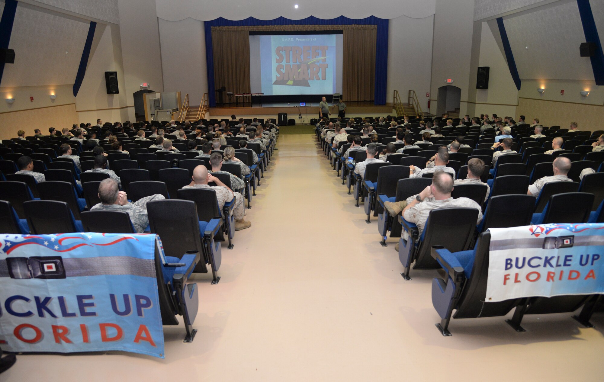 Members of Team MacDill listen to a “Street Smart” presentation at MacDill Air Force Base, Fla., May 19, 2015. “Street Smart” is a non-profit organization dedicated to making young adults aware of the dangers of driving under the influence of alcohol or drugs, distracted driving, not wearing seat belts, and the trauma associated with these dangers. (U.S. Air Force photo by Senior Airman Vernon L. Fowler Jr./Released)