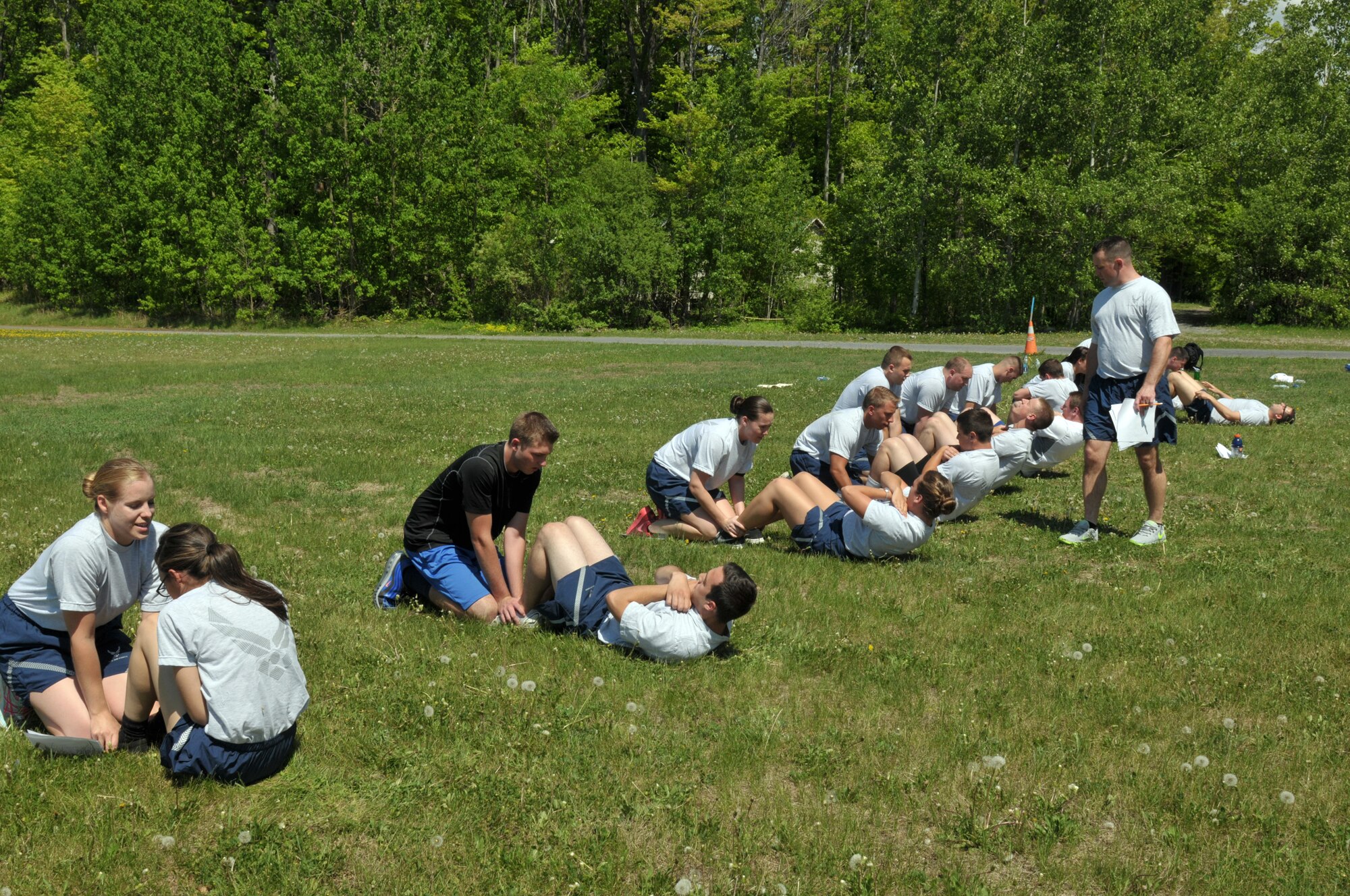 Trainees with the 109th Student Flight perform a mock physical training test May 17, 2015, at Stratton Air National Guard Base, New York. Regular PT is just one of many changes the Student Flight recently underwent to help ensure 100-percent graduation at Basic Military Training. (U.S. Air National Guard photo by Master Sgt. Christine Wood/Released)