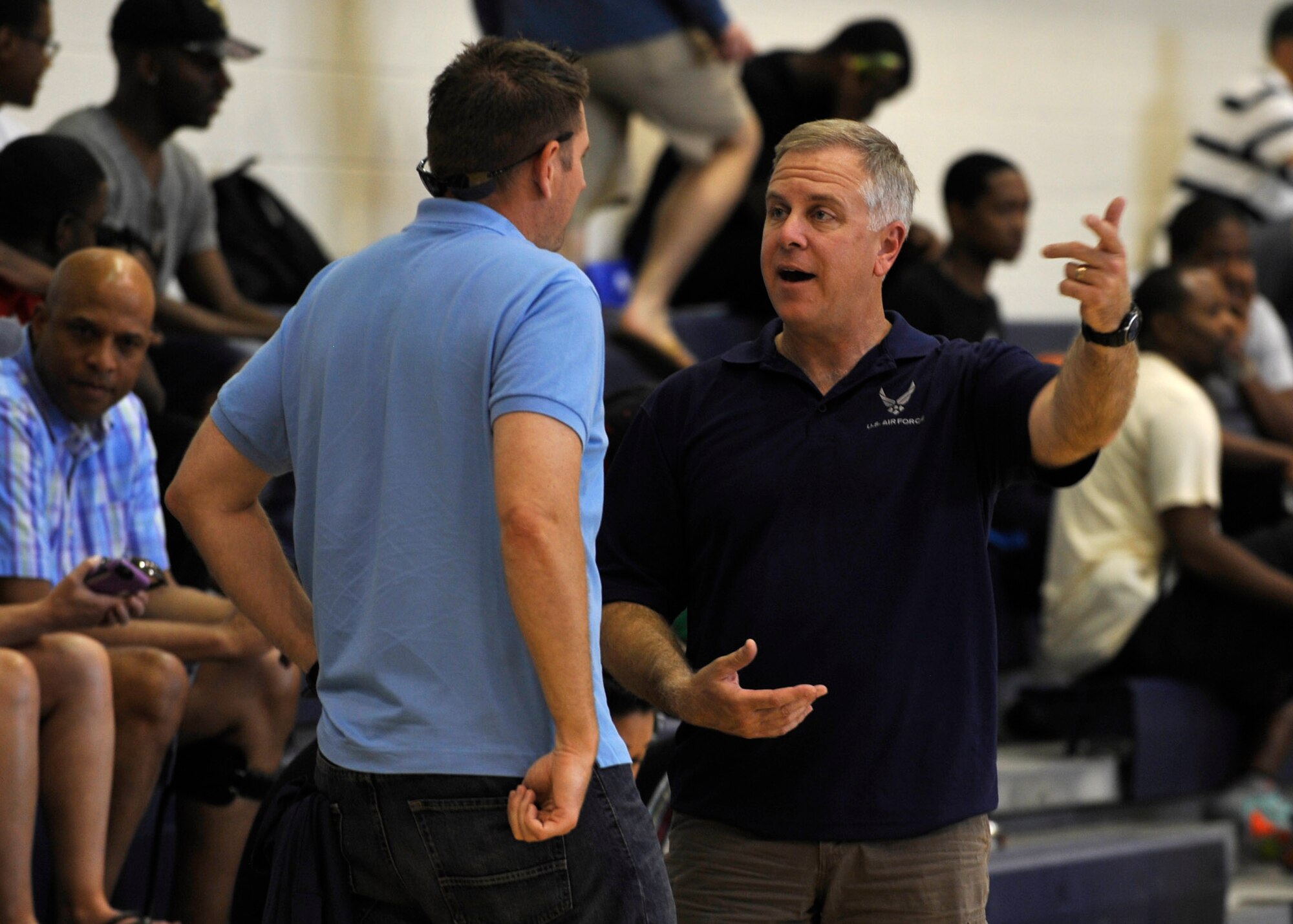 U.S. Air Force Col. John Allen, 633rd Air Base Wing Commander talks to Lt. Col. Gregory Beaulieu, 633rd Force Support Squadron Commander, at the 1st Mid-Atlantic Intra-Military Basketball Tournament at Joint Base Langley-Eustis, Va., May 16, 2015. U.S. Service members and families were all invited to watch the games. (U.S. Air Force photo by Senior Airman Breonna Veal)