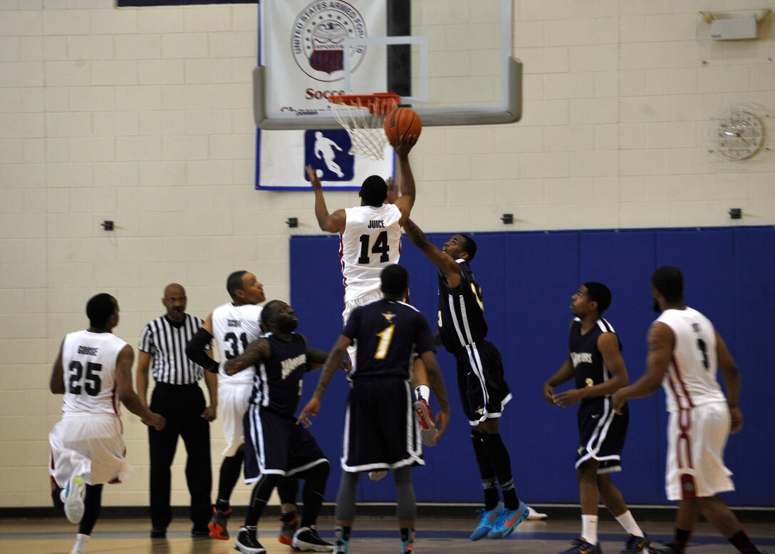 A Langley Raptor scores a point against the Naval Support Activity-Bethesda Warriors at the 1st Mid-Atlantic Intra-Military Basketball Tournament at Joint Base Langley-Eustis, Va., May 16, 2015. The tournament consisted of eight intra-military teams from the east coast region to include the Norfolk Naval Station and Fort Lee.(U.S. Air Force photo by Senior Airman Breonna Veal)