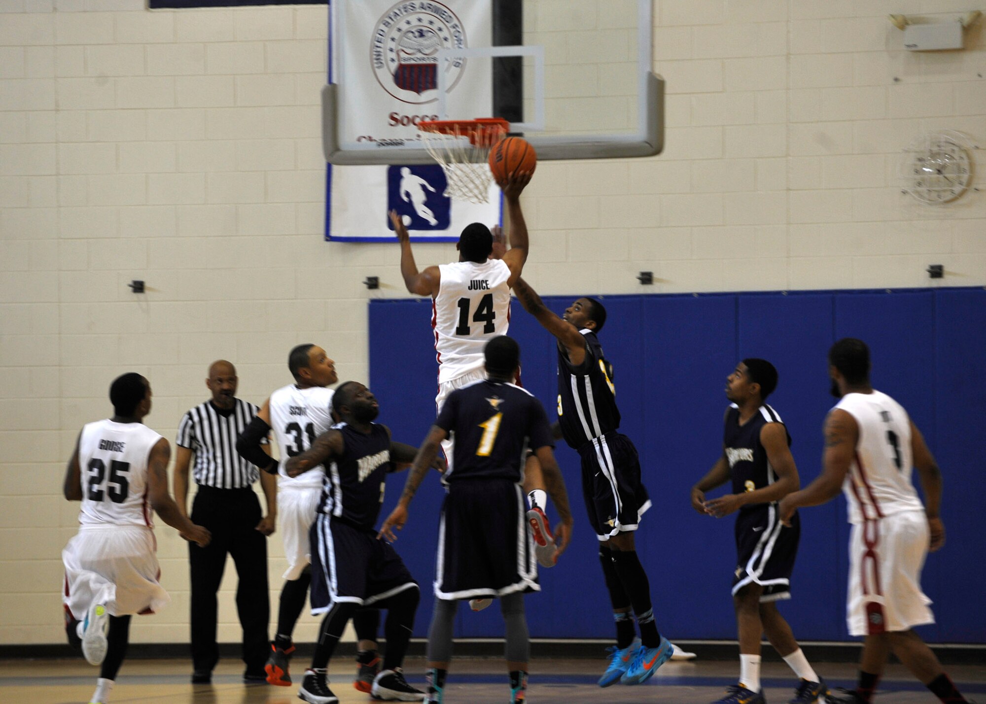 A Langley Raptor scores a point against the Naval Support Activity-Bethesda Warriors at the 1st Mid-Atlantic Intra-Military Basketball Tournament at Joint Base Langley-Eustis, Va., May 16, 2015. The tournament consisted of eight intra-military teams from the east coast region to include the Norfolk Naval Station and Fort Lee.(U.S. Air Force photo by Senior Airman Breonna Veal)