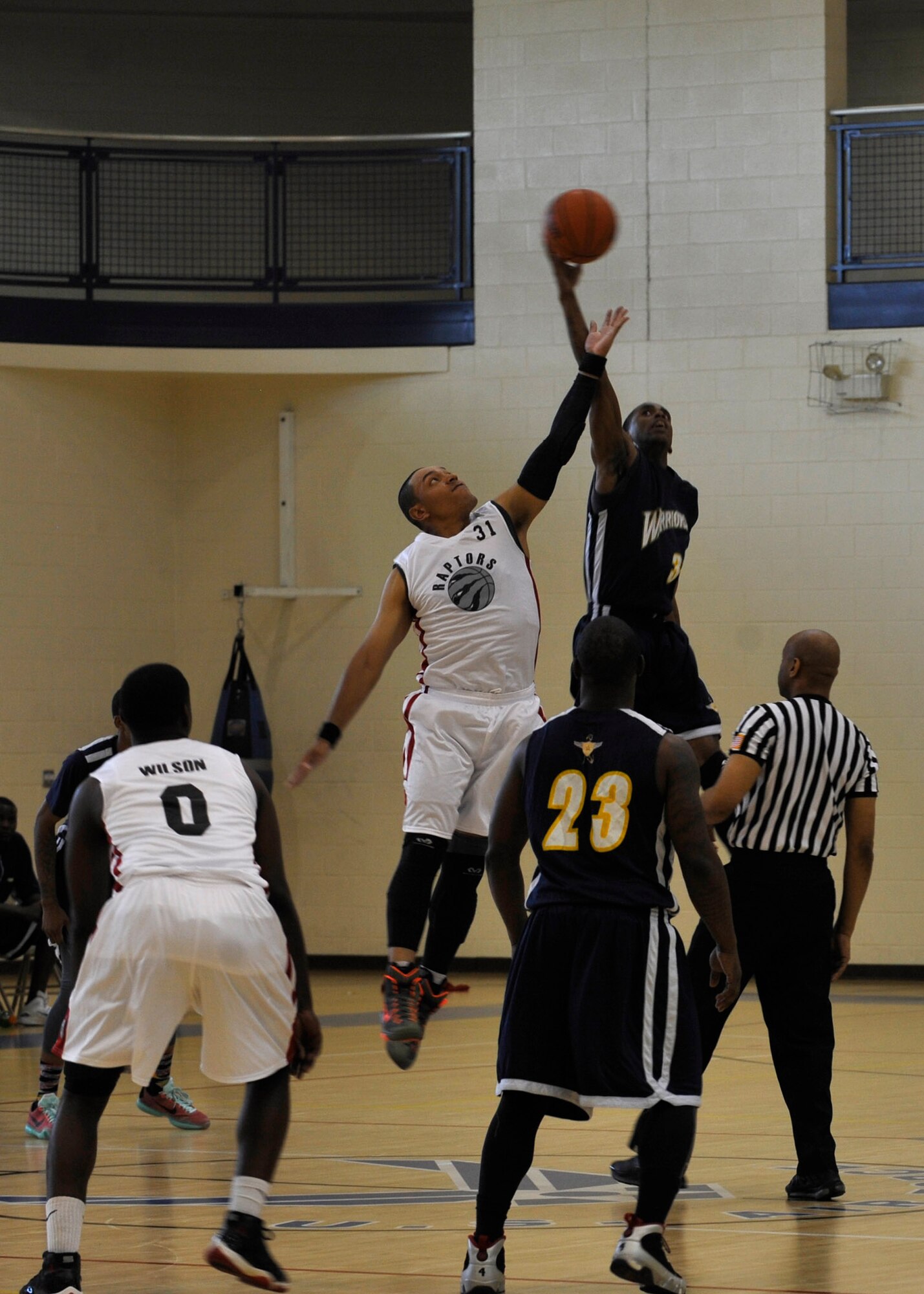 A Langley Raptor and a Naval Support Activity-Bethesda Warrior complete a jump ball for possession at the 1st Mid-Atlantic Intra-Military Basketball Tournament at Joint Base Langley-Eustis, Va., May 16, 2015. The tournament was double-elimination, which meant teams had to lose two games before being eliminated completely. (U.S. Air Force photo by Senior Airman Breonna Veal)