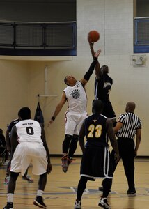 A Langley Raptor and a Naval Support Activity-Bethesda Warrior complete a jump ball for possession at the 1st Mid-Atlantic Intra-Military Basketball Tournament at Joint Base Langley-Eustis, Va., May 16, 2015. The tournament was double-elimination, which meant teams had to lose two games before being eliminated completely. (U.S. Air Force photo by Senior Airman Breonna Veal)