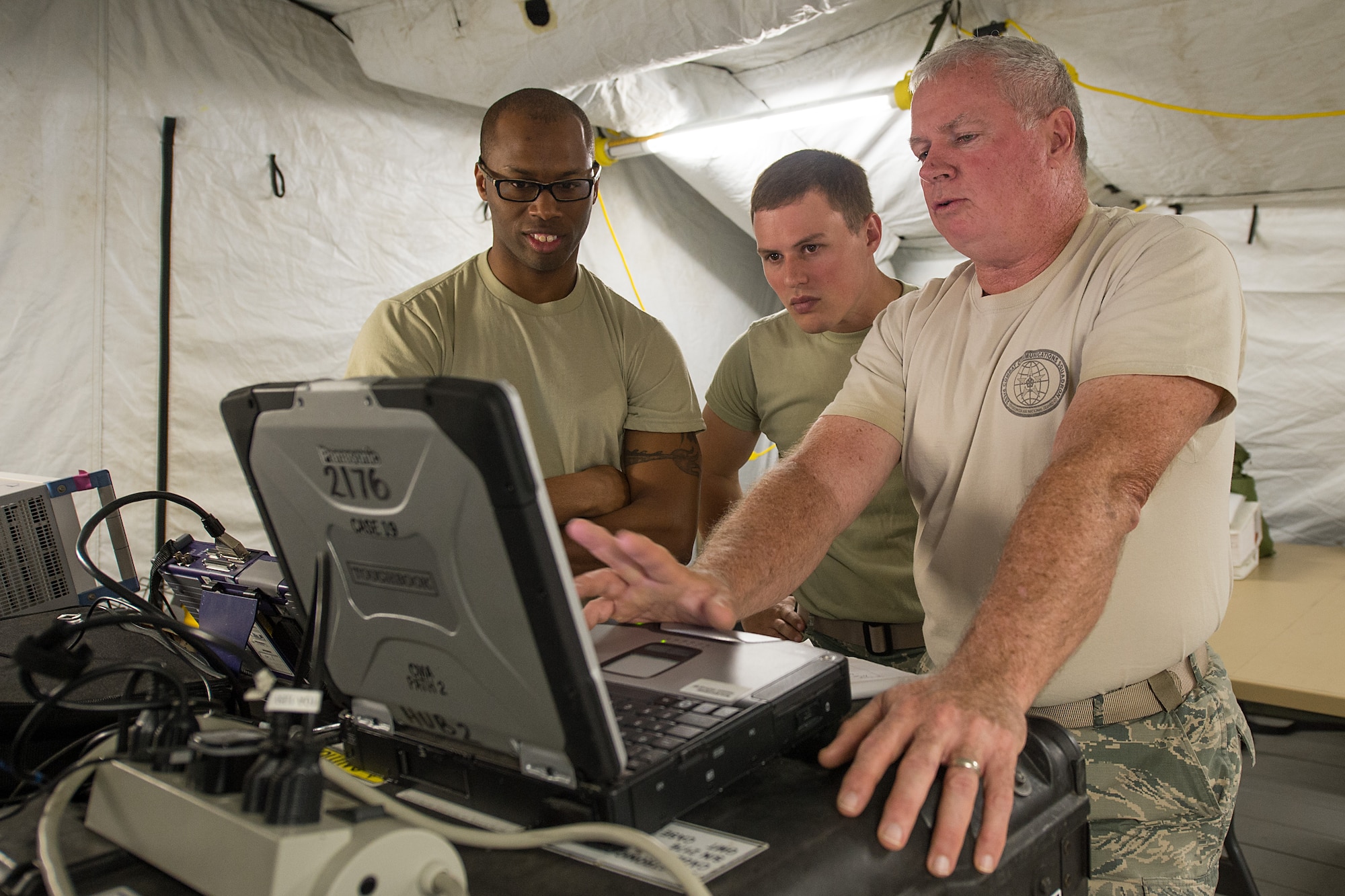 An RF transmission superintendent, right, with the 283rd Combat Communications Squadron (CCS) from Dobbins Air Reserve Base, Georgia Air National Guard, discusses satellite transmission data information obtained from a Theater Deployable Communications System with two Airmen from the 117th Air Control Squadron during the Sentry Savannah 15-2 exercise at The Air Dominance Center, Savannah, Ga., May 10, 2015. Sentry Savannah is a National Guard Bureau sponsored training event with a focus on Joint Dissimilar Air Combat Training and 5th Generation Fighter Integration. It offers a chance for fighter pilots to participate in war simulations that depict what they would face in real-world scenarios. During the exercise the 283rd CBCS provided NIPR, SIPR, and voice services to the 117th Air Control Squadron Air Battle Element and extended service to their deployed radar site. Working together the two units provided vital data to help the fighter pilots complete their missions. (U.S. Air National Guard photo by the 116th Air Control Wing Public Affairs/Released) (Names of military personnel have been withheld for security purposes)