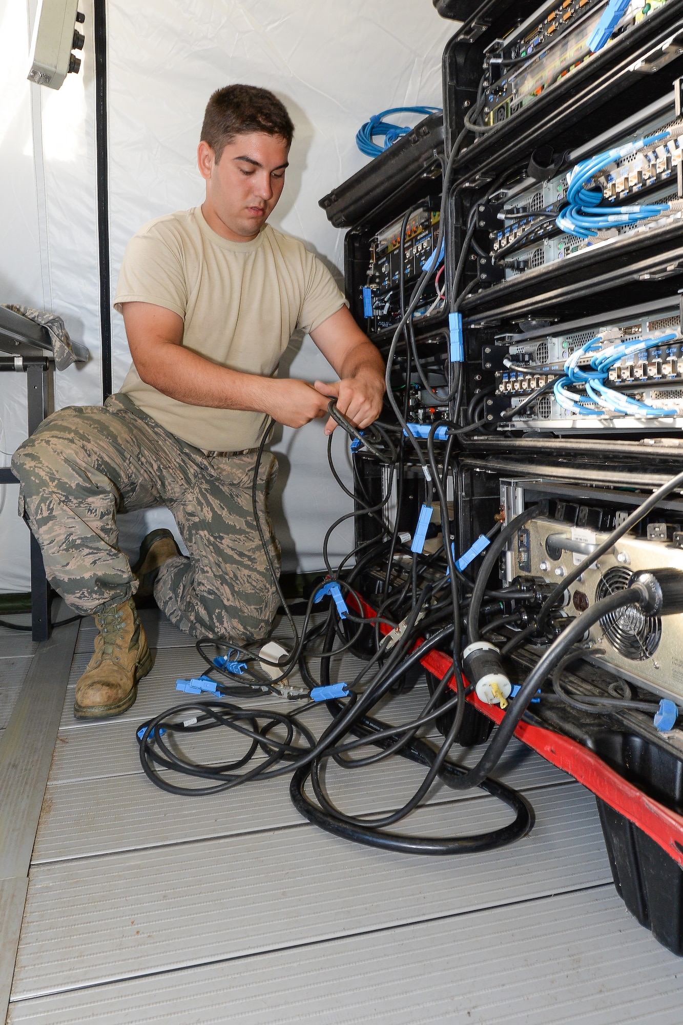 A U.S. Air Force cyber systems operator with the 283rd Combat Communications Squadron (CCS) from Dobbins Air Reserve Base, Georgia Air National Guard, connects cables during set up of a Theater Deployable Communications System during the Sentry Savannah 15-2 exercise at The Air Dominance Center, Savannah, Ga., May 8, 2015. Sentry Savannah is a National Guard Bureau sponsored training event with a focus on Joint Dissimilar Air Combat Training and 5th Generation Fighter Integration. It offers a chance for fighter pilots to participate in war simulations that depict what they would face in real-world scenarios. During the exercise the 283rd CBCS provided NIPR, SIPR, and voice services to the 117th Air Control Squadron Air Battle Element and extended service to their deployed radar site. Working together the two units provided vital data to help the fighter pilots complete their missions. (U.S. Air National Guard photo by the 116th Air Control Wing Public Affairs/Released) (Name of military member withheld for security purposes)