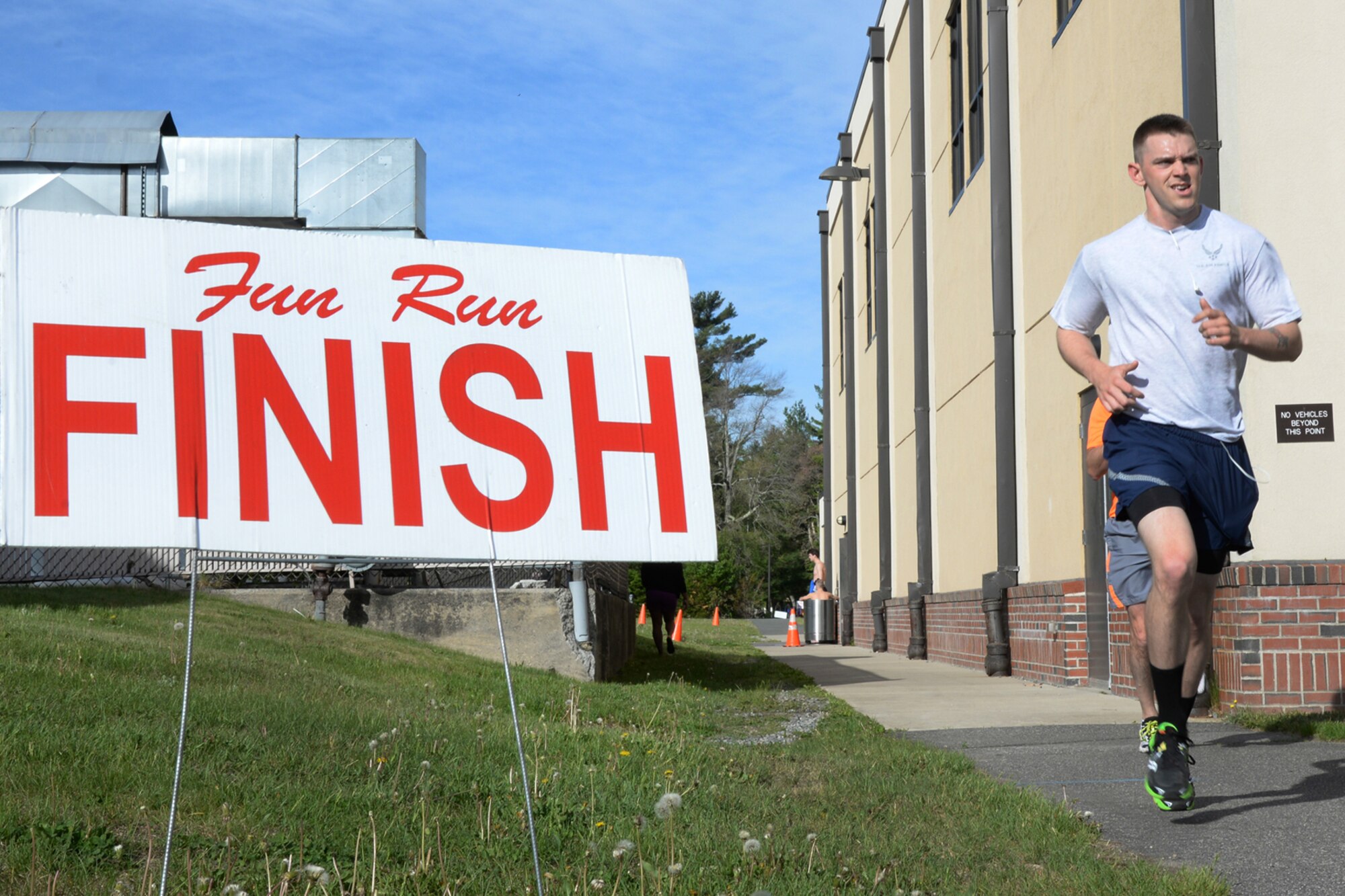 Staff Sgt. Garrison Cullers, Jr., 66th Force Support Squadron ceremonial guardsman, crosses the finish line during the Battle Road Run outside the Sports and Fitness Center May 20. The top finishers in the male category were 1st Lt. Aaron Zadalis, 19:11; Gerard Cavallo, 19:13; and Sawyer Krueger, 21:51. The top female finishers were Kristen Ceglowski, 21:49; Katy Murray, 23:15; and Bernadette Berger, 23:22. (U.S. Air Force photo by Linda LaBonte Britt)