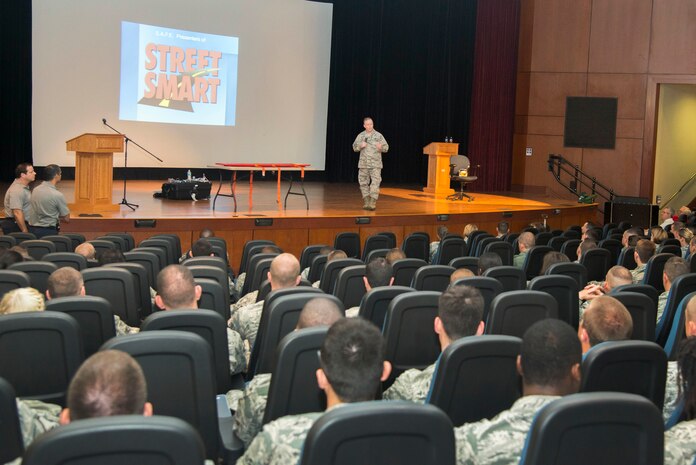 Col. Jeffrey DeVore, Joint Base Charleston commander, briefs members of JB Charleston on the importance of safety practices during the annual Street Smart safety briefing, May 14, 2015 at the Air Base Theater. The briefing contained detailed videos and demonstrations on practicing good safety and using common sense to prevent serious injury or death. (U.S. Air Force photo/Senior Airman George Goslin)