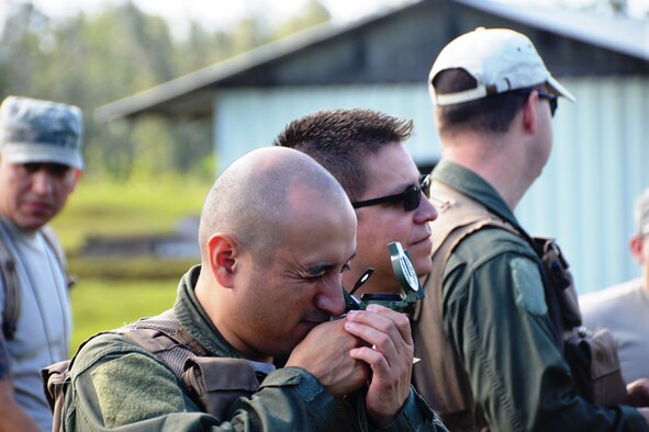 A 433rd Airlift Wing aircrew member looks through a compass during land navigation training, May 16, 2015 at Hilo, Hawaii. More than 140 members participated in exercise “Aloha Stampede.” Other training included, self aid and buddy care, water survival training, air-refueling, cargo preparation, and increment monitoring of cargo for inspection during all phases of the exercise to include pre-deployment, deployment, and redeployment. (U.S. Air Force photo/Minnie Jones)   