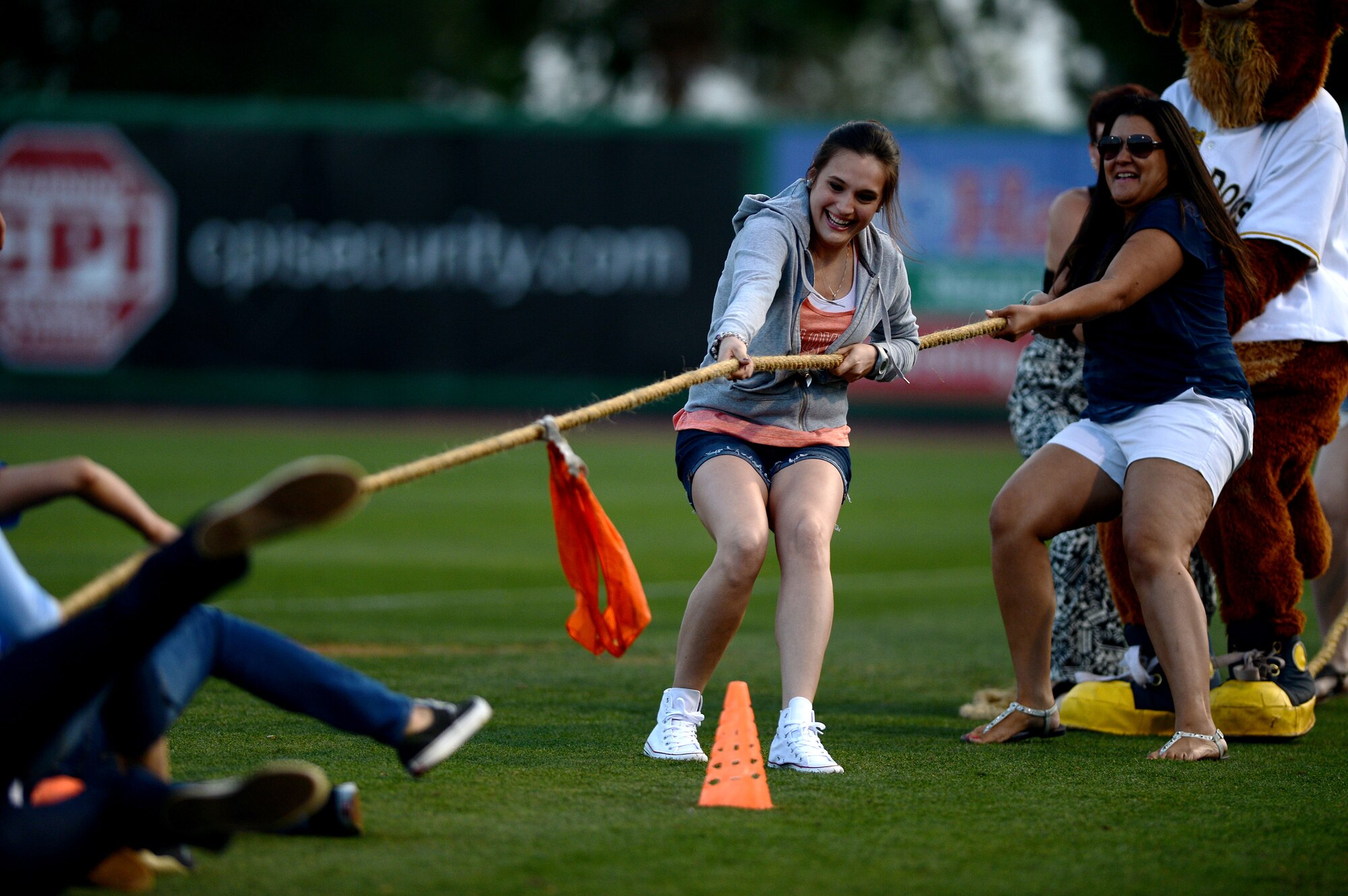 U.S. Air Force spouses play tug-o-war during a military appreciation baseball game at the Joseph P. Riley Jr. Ballpark in Charleston, S.C., May 14, 2015. Throughout the game, several military related events were held to show military support. (U.S. Air Force photo by Senior Airman Jensen Stidham/Released) 
