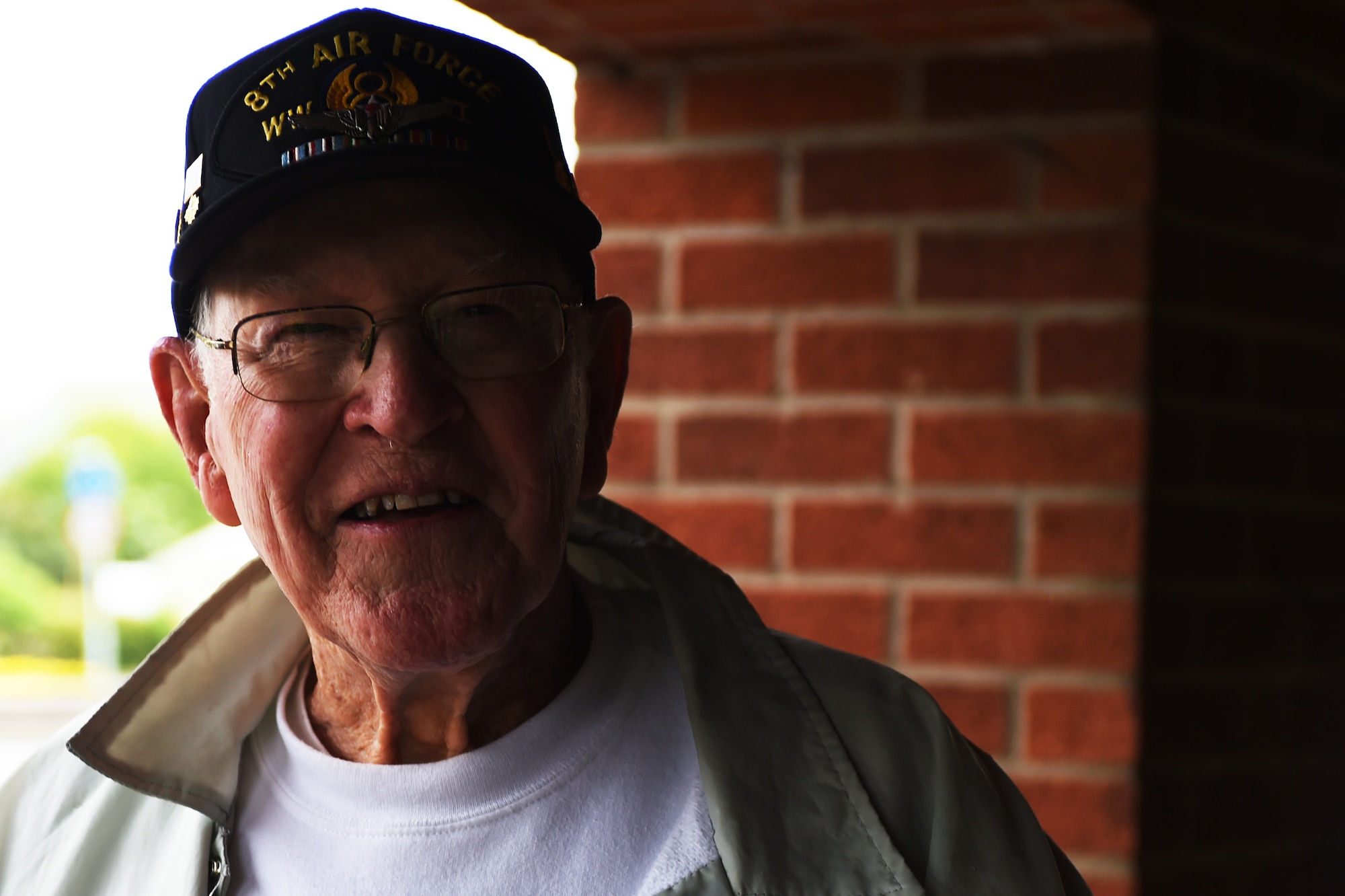 Former U.S. Army Air Corps Tech. Sgt., and World War II veteran, Bill Toombs stands at the entrance to RAF Alconbury, England, May 18, 2015. Toombs was stationed at RAF Debach during the war, as a B-24 Liberator and B-17 Flying Fortress flight engineer and gunner. (U.S. Air Force photo by Staff Sgt. Jarad A. Denton/Released)